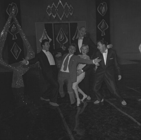 Five actors performing on stage