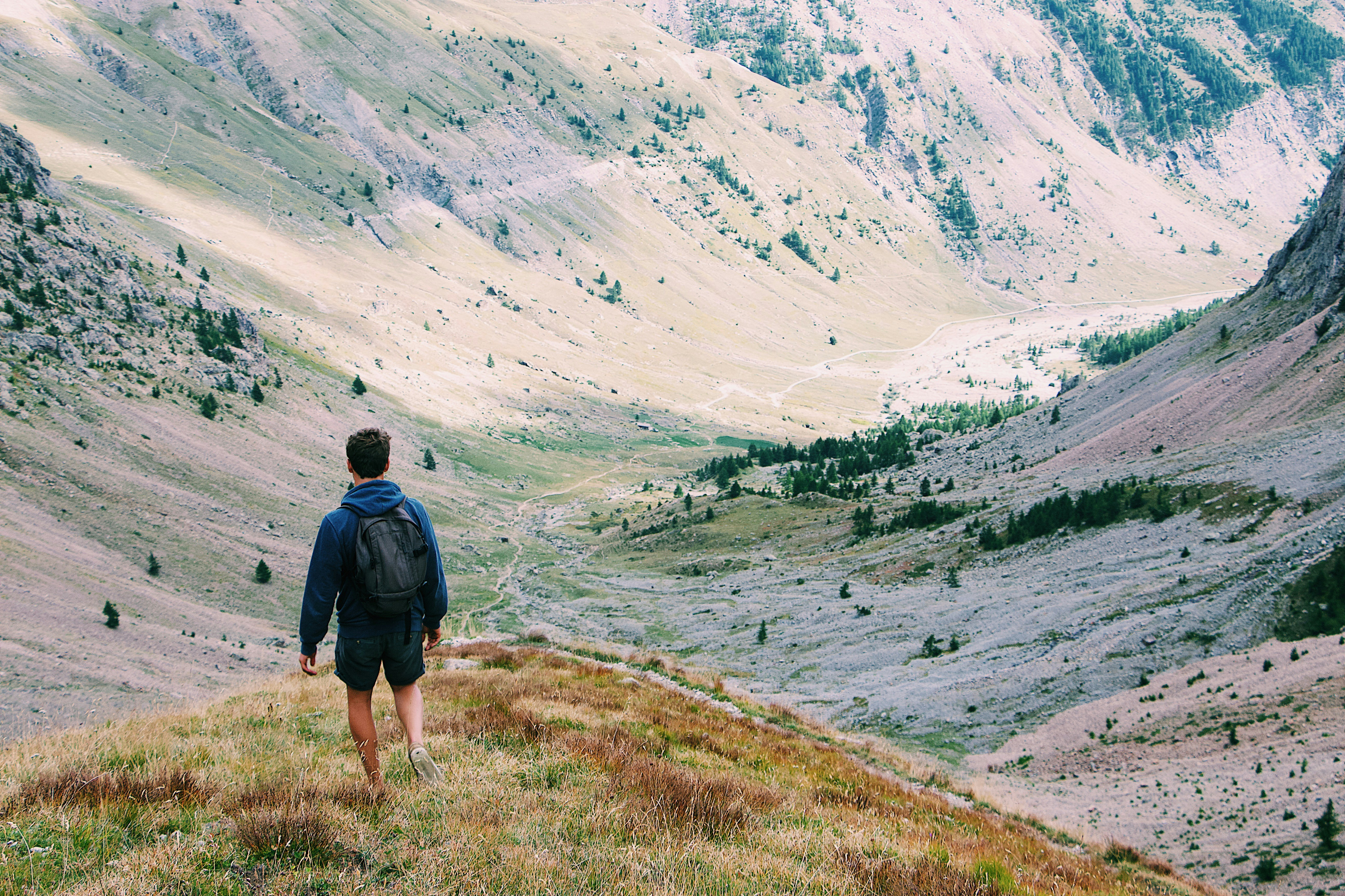 Hiker Descending Mountain Valley