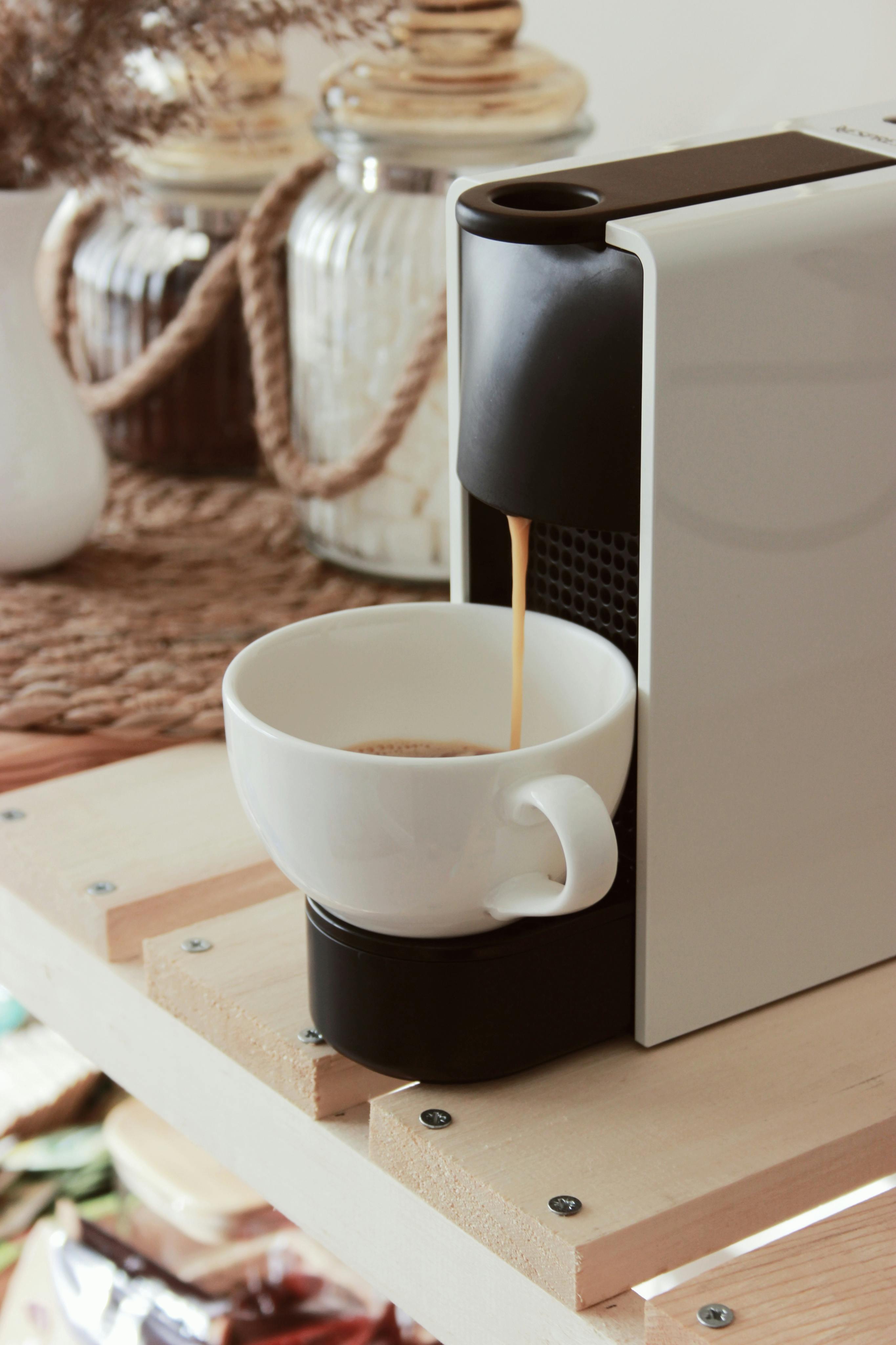 Coffee Pouring Into Cup From Coffee Machine