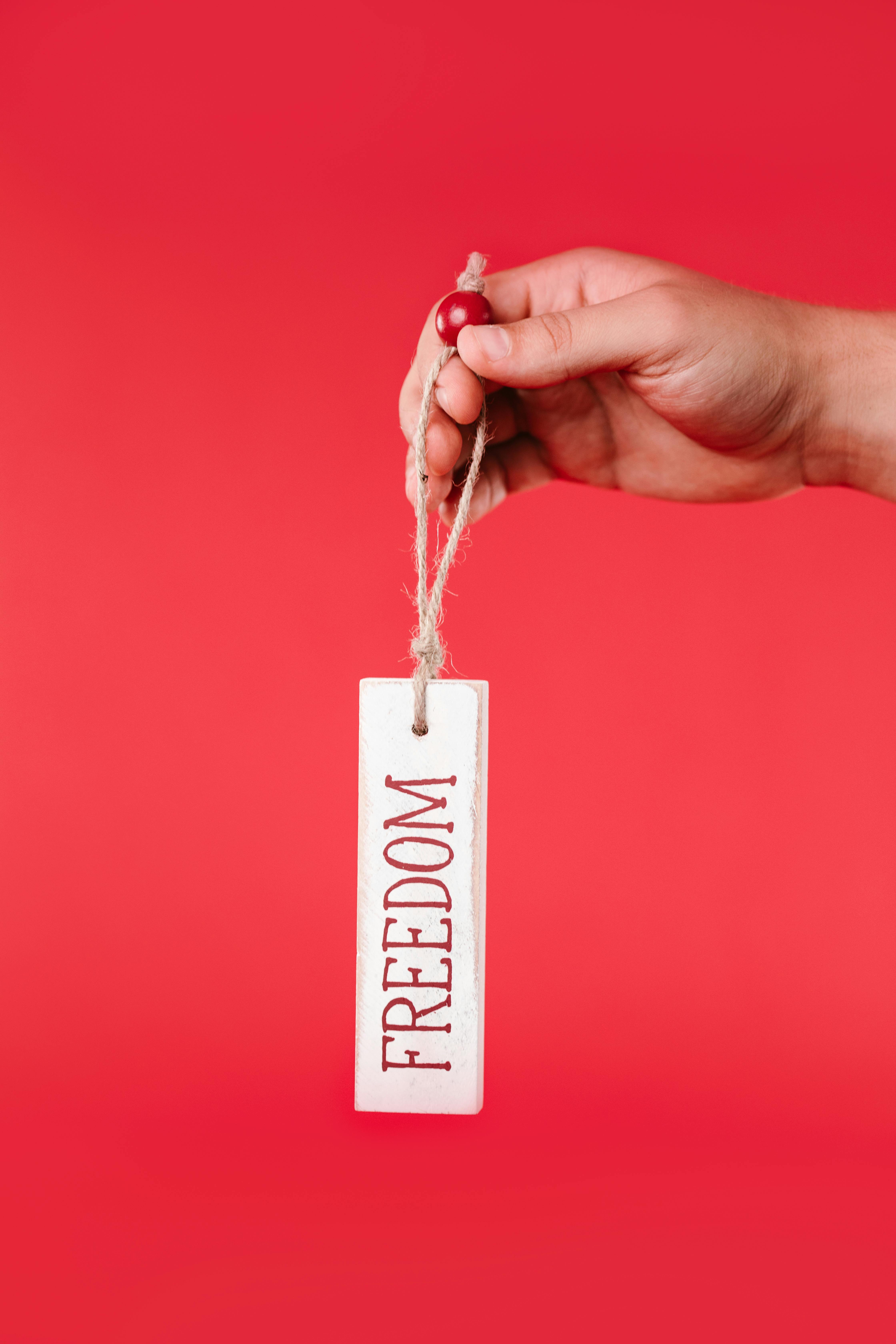 Hand Holding Freedom Tag