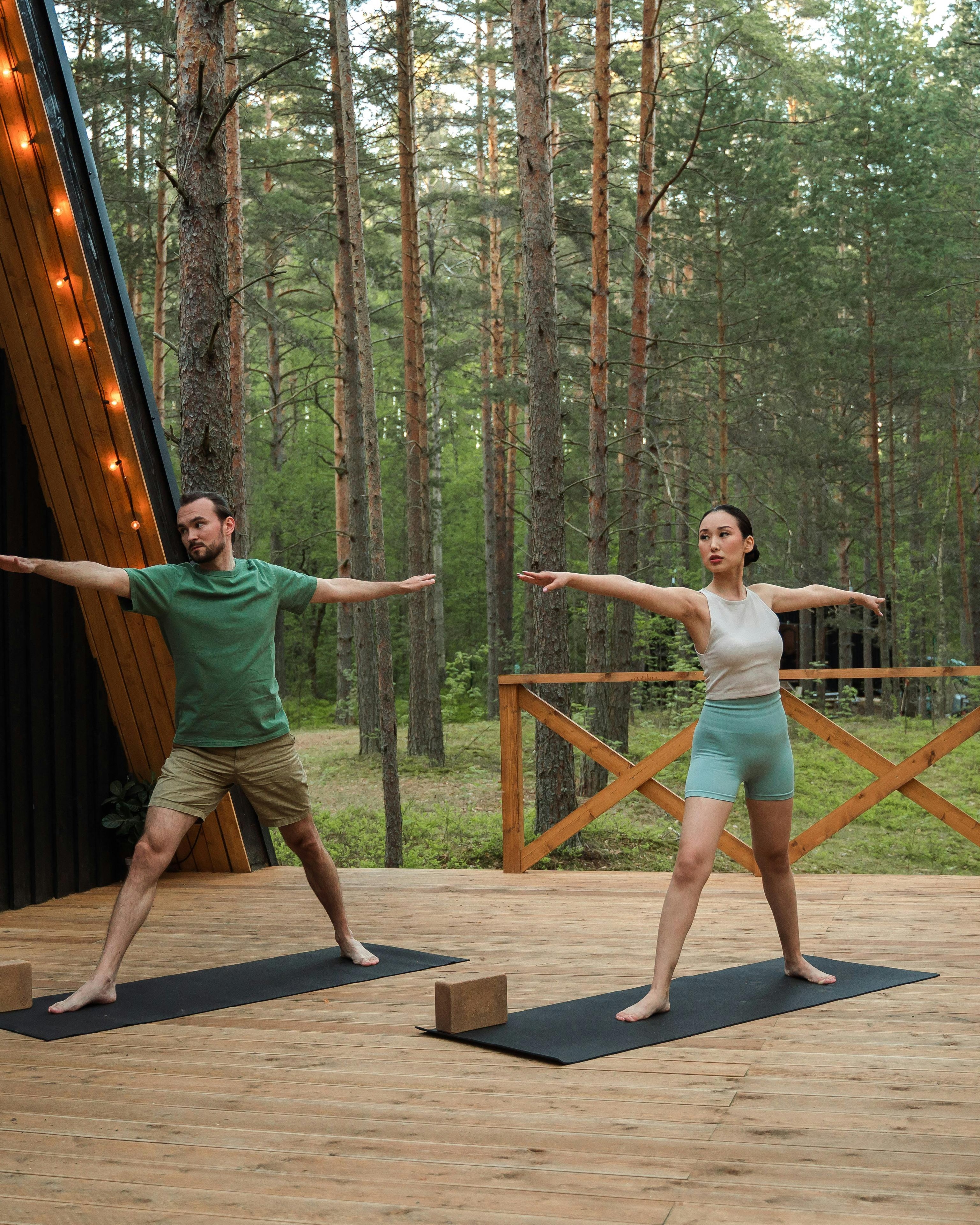 Two People Practicing Outdoor Yoga in Forest