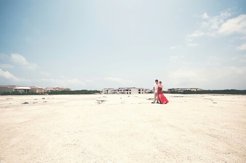 Couple Embracing on Open Sandy Ground