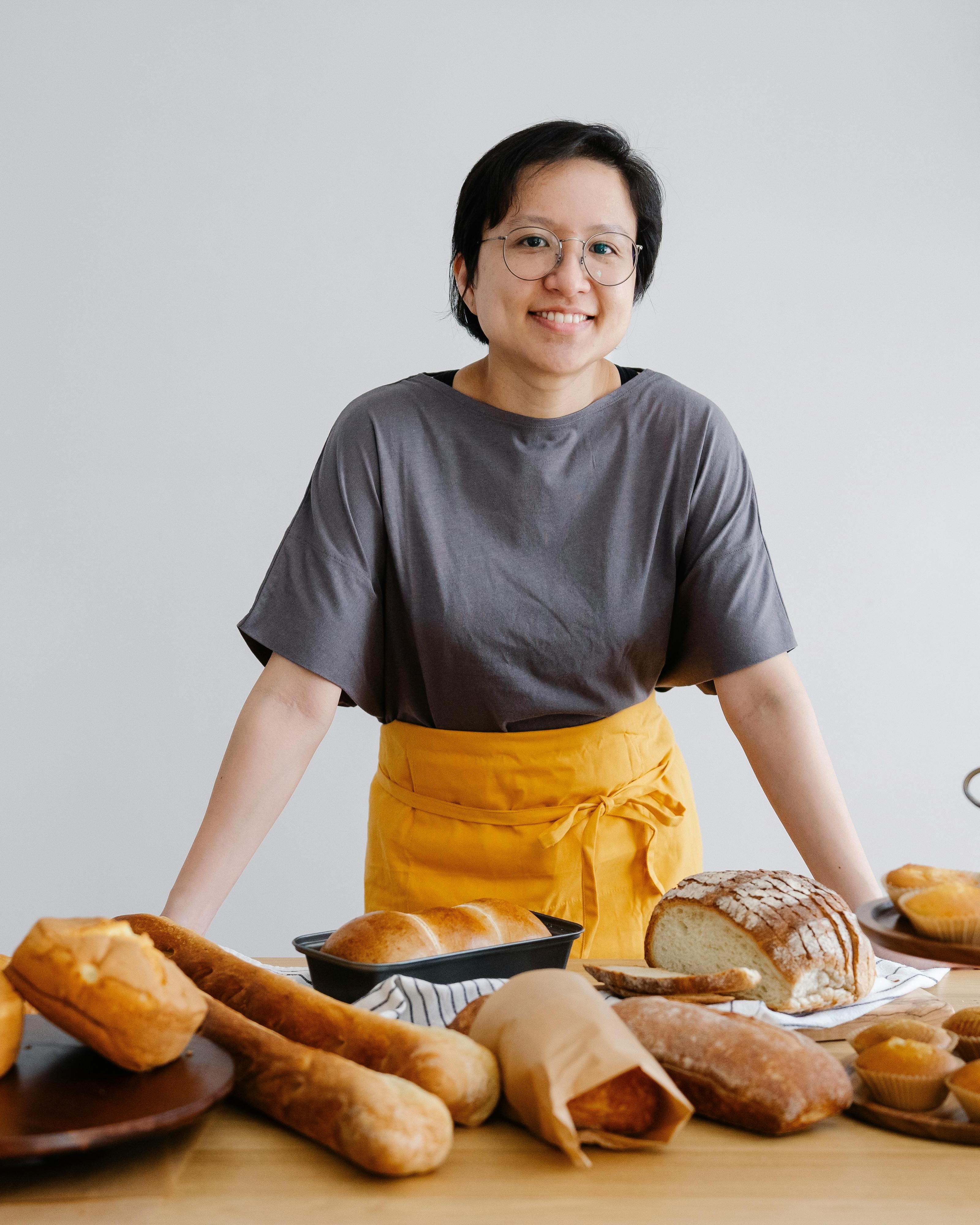Female Baker With Assorted Homemade Breads