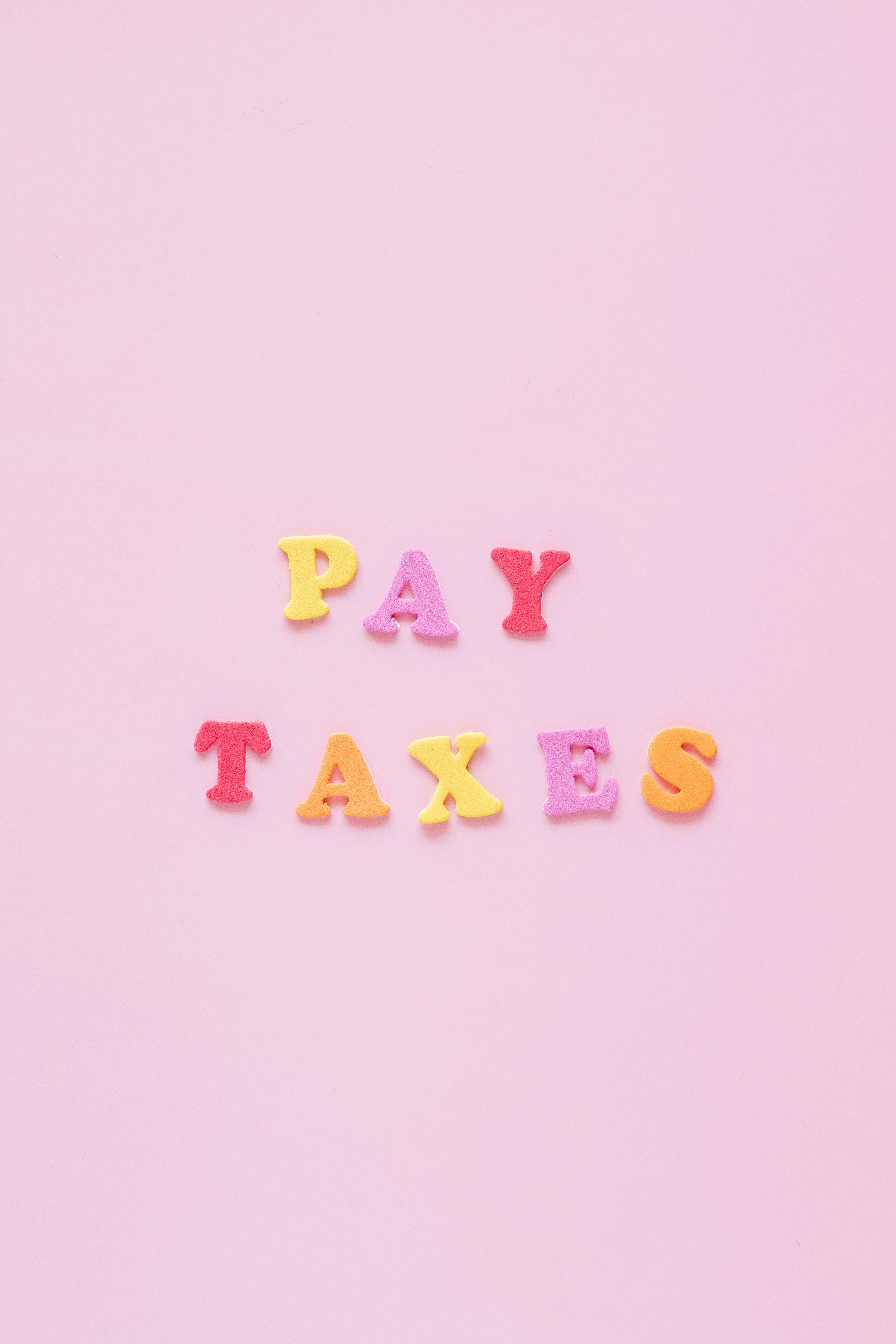 Pay Taxes Text on Pink Background