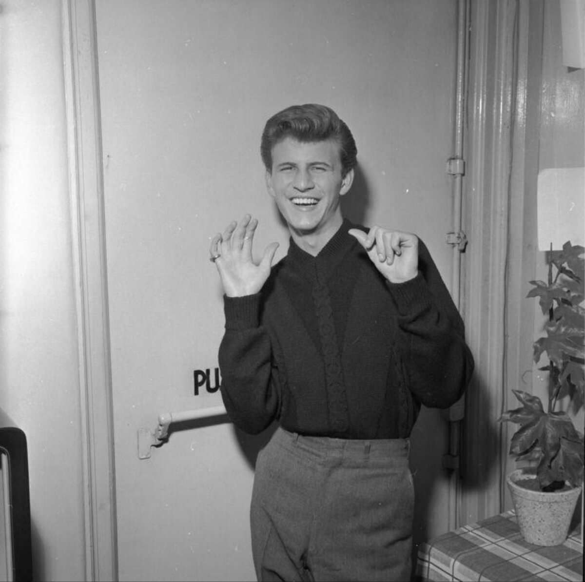 Smiling Young Man Posing By Door