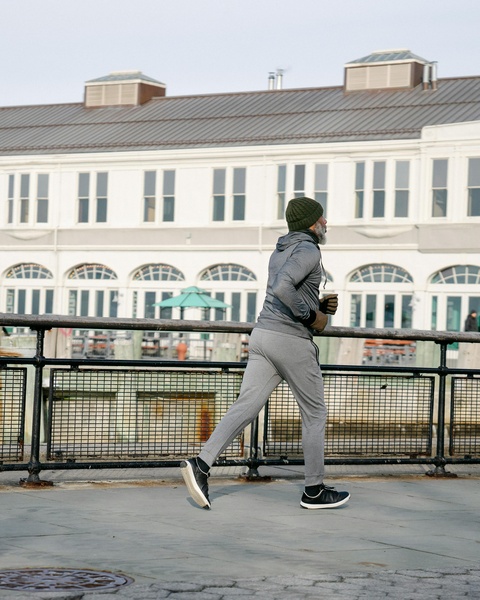 Senior Man Jogging on Waterfront Promenade