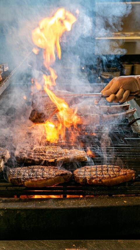Steaks Grilling Over Open Fire