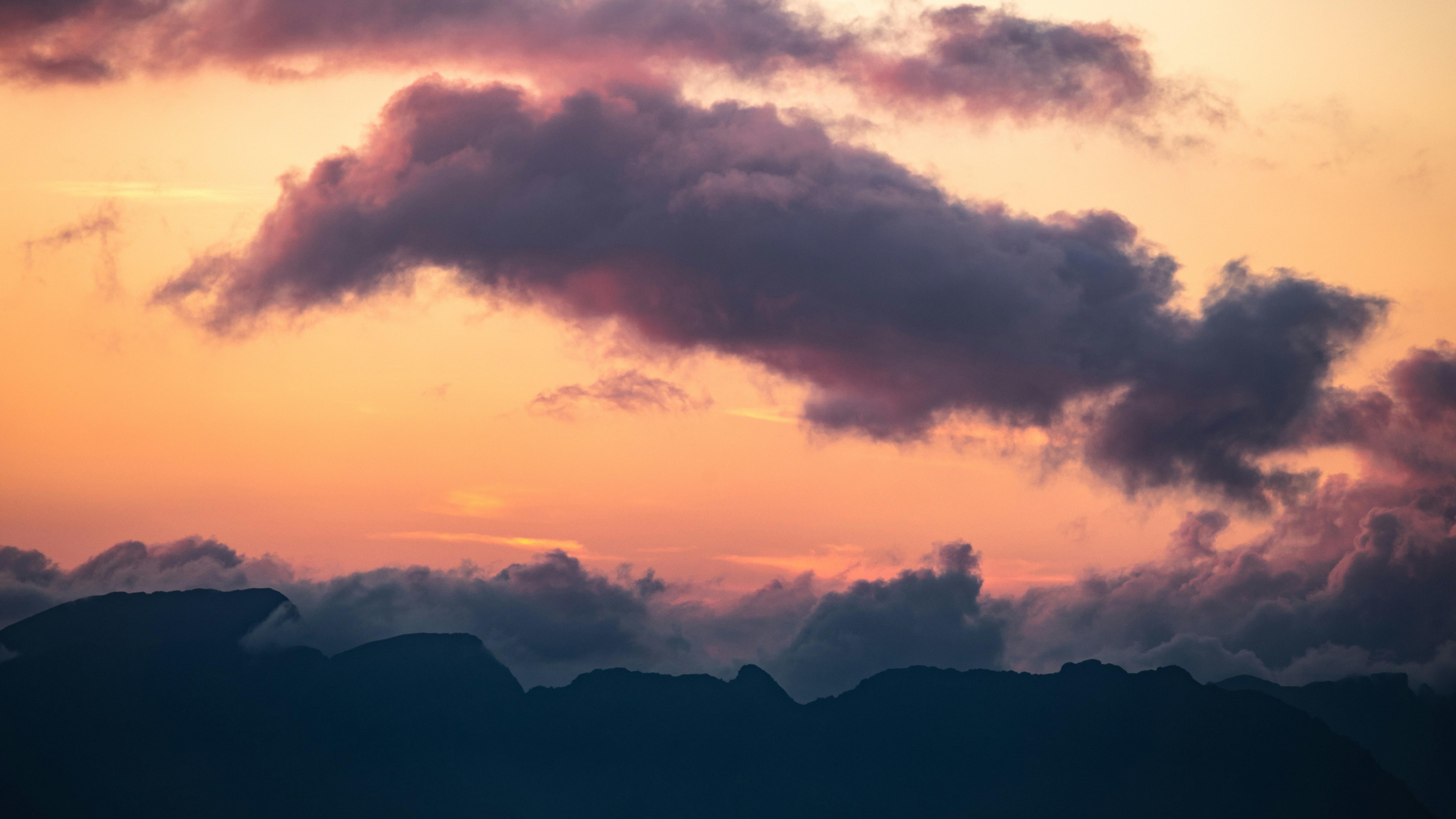 Sunset Sky Over Silhouetted Mountains