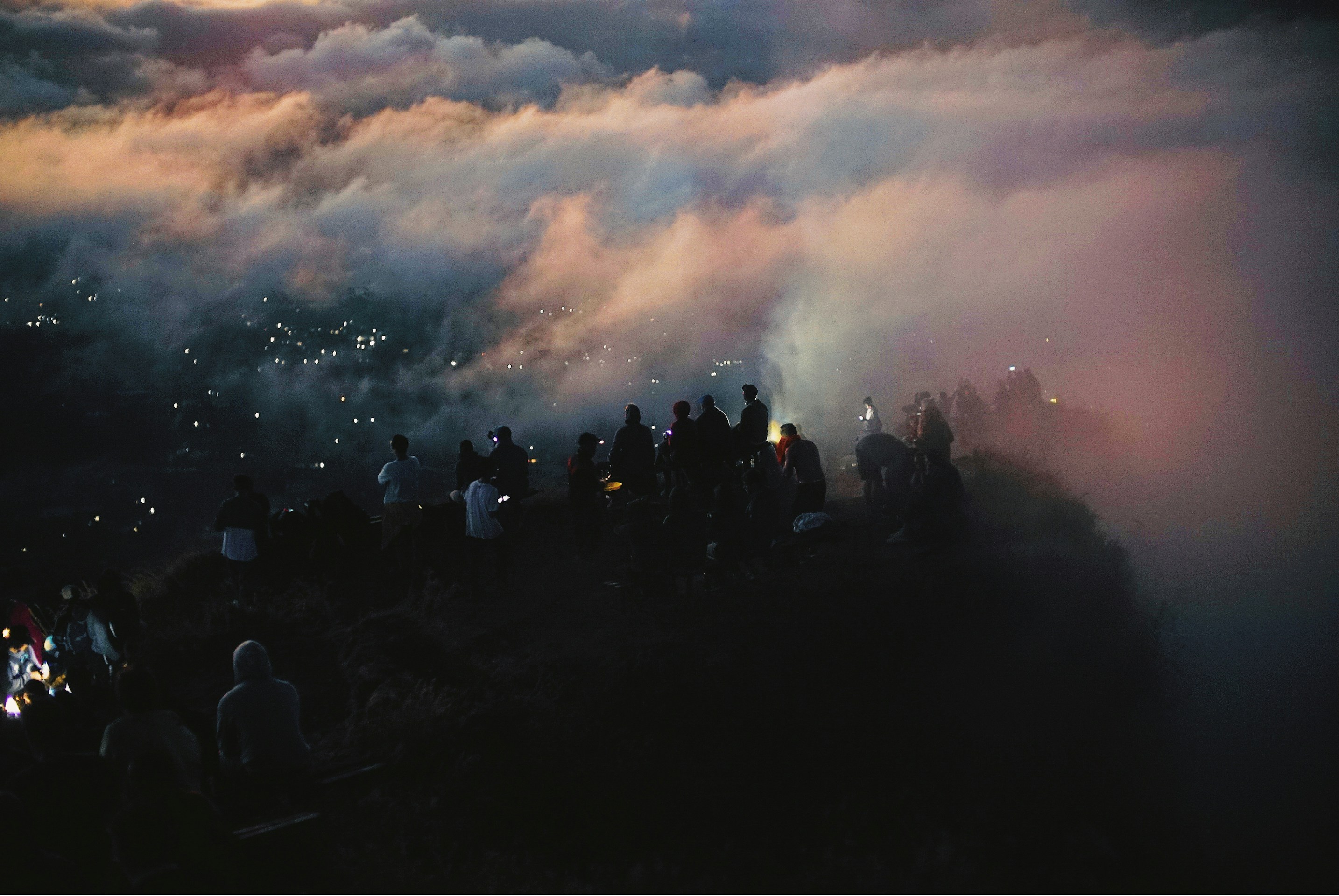 Crowd on Mountain Ridge Above Clouds