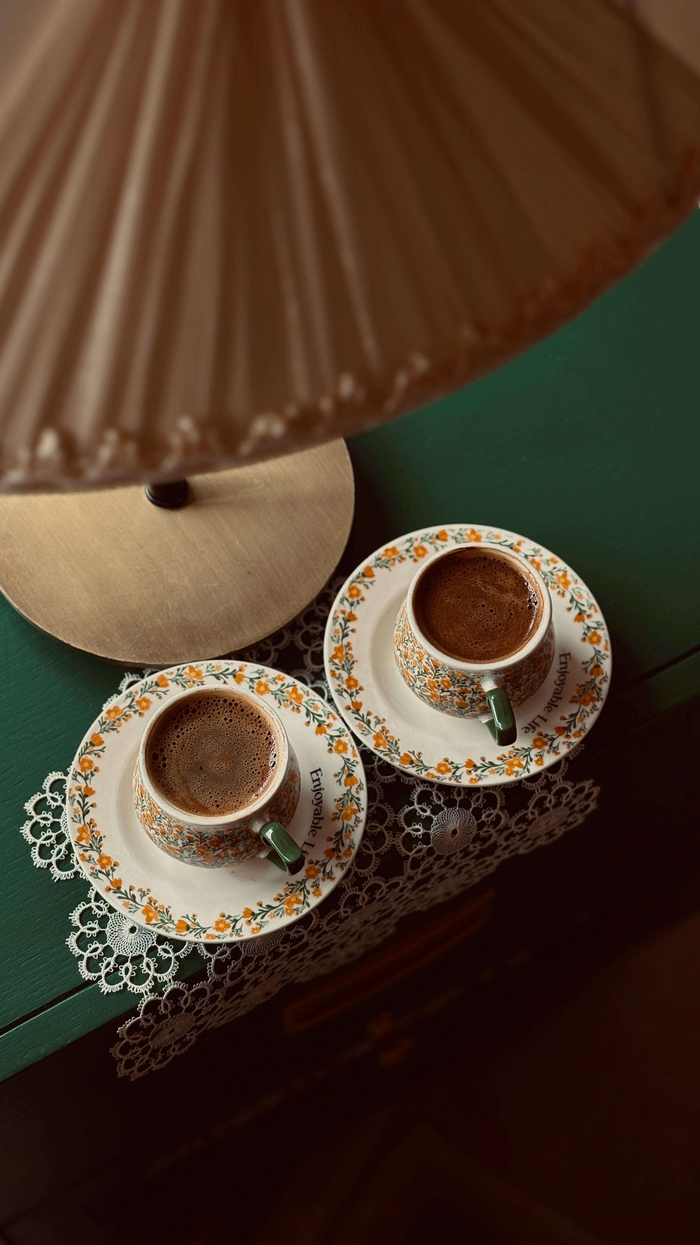 Two Coffee Cups on Green Side Table
