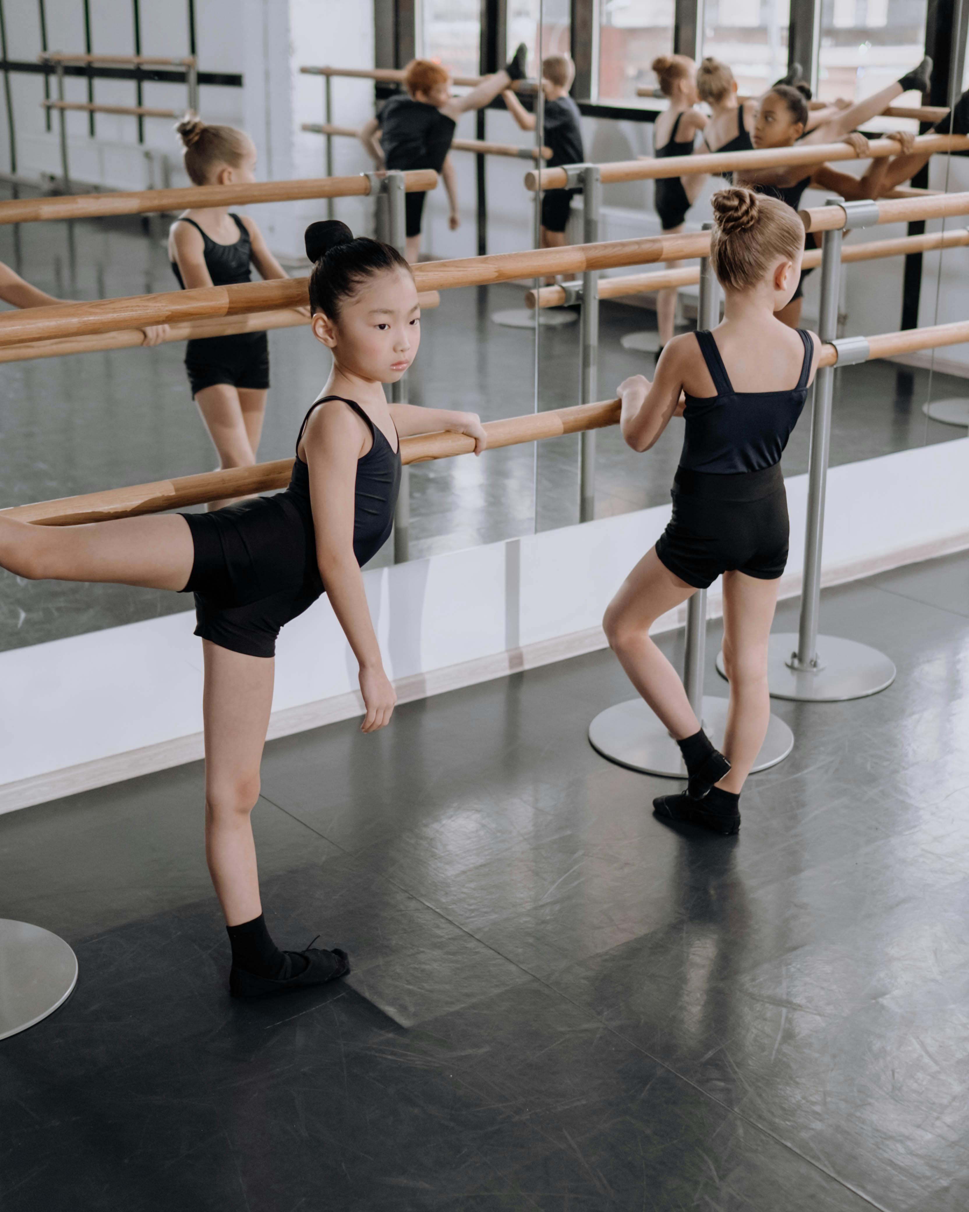 Young Ballet Students Stretching at Barre