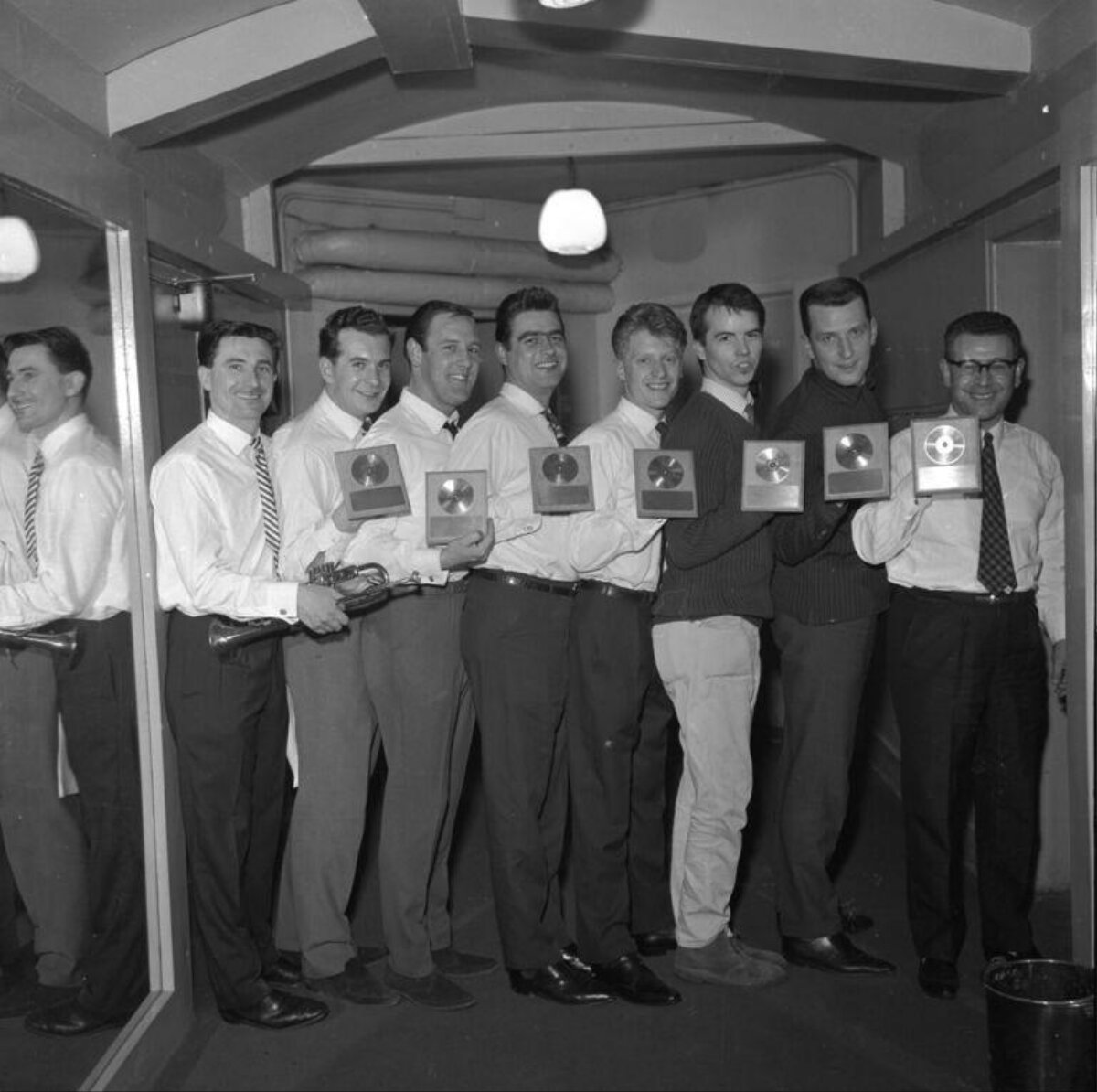 Eight Men Holding Gold Record Awards