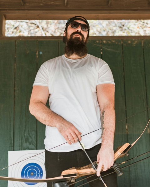 Bearded Man Preparing for Archery