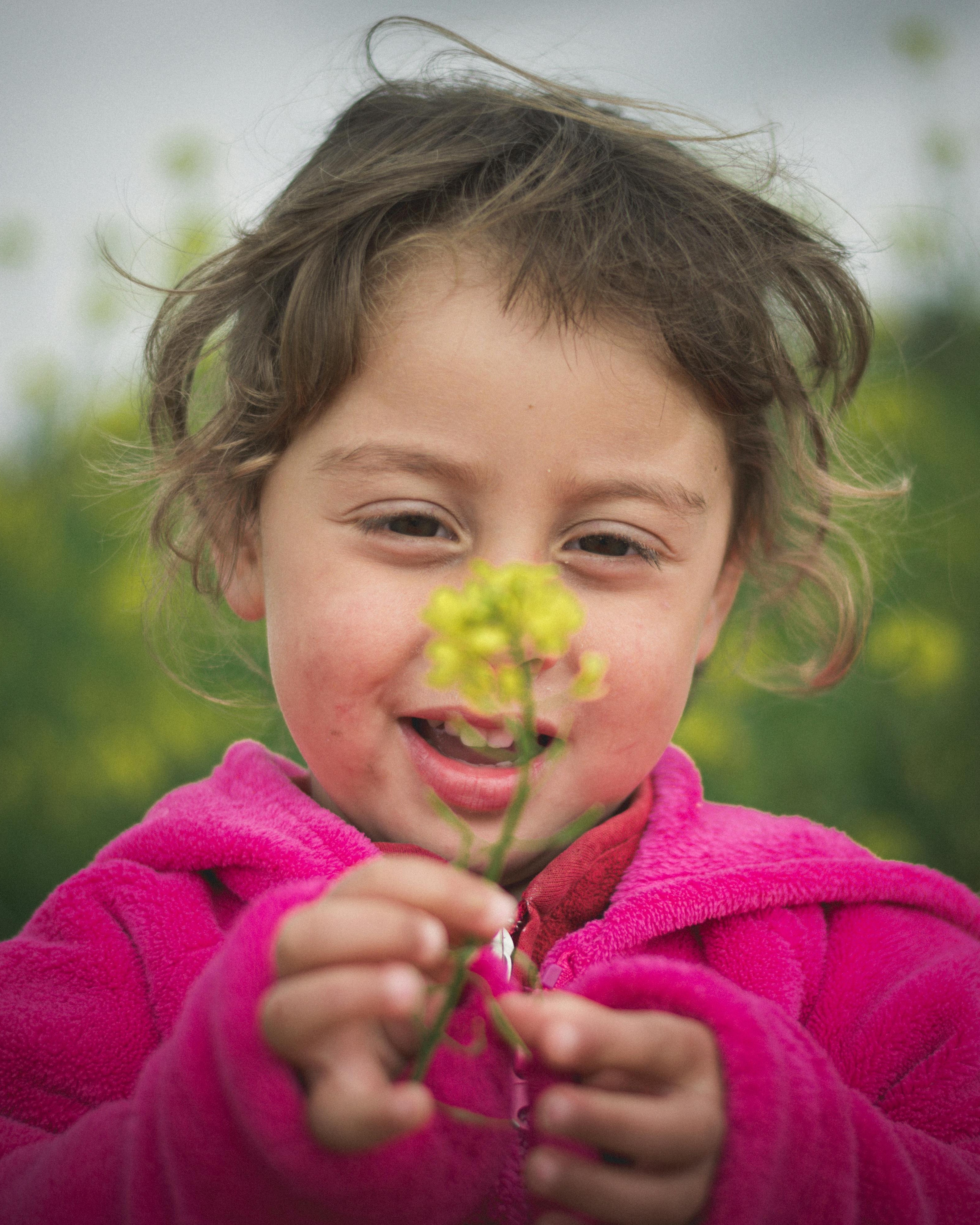 Young Girl Holding Yellow Flower