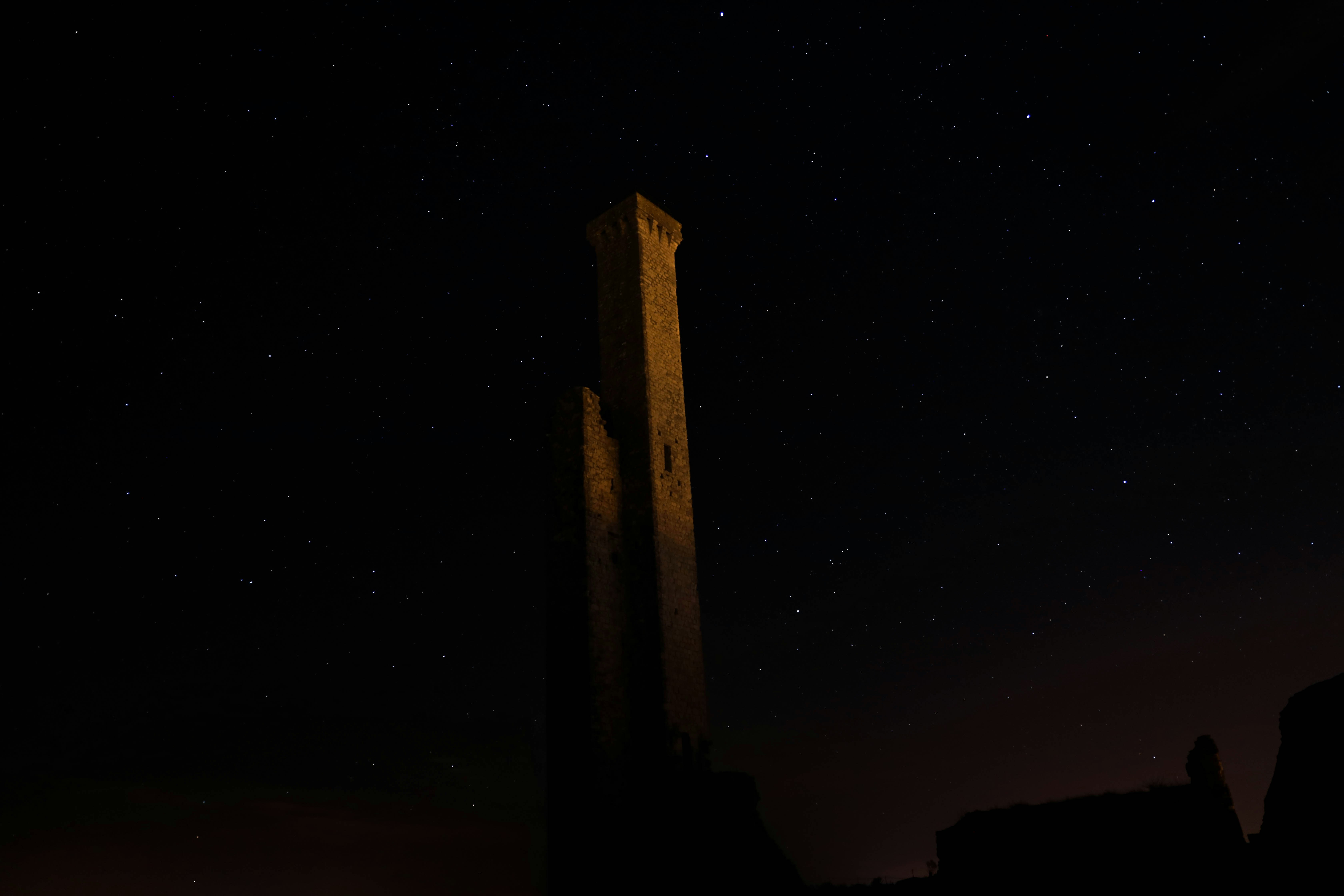 Ancient Stone Tower Under Starry Night