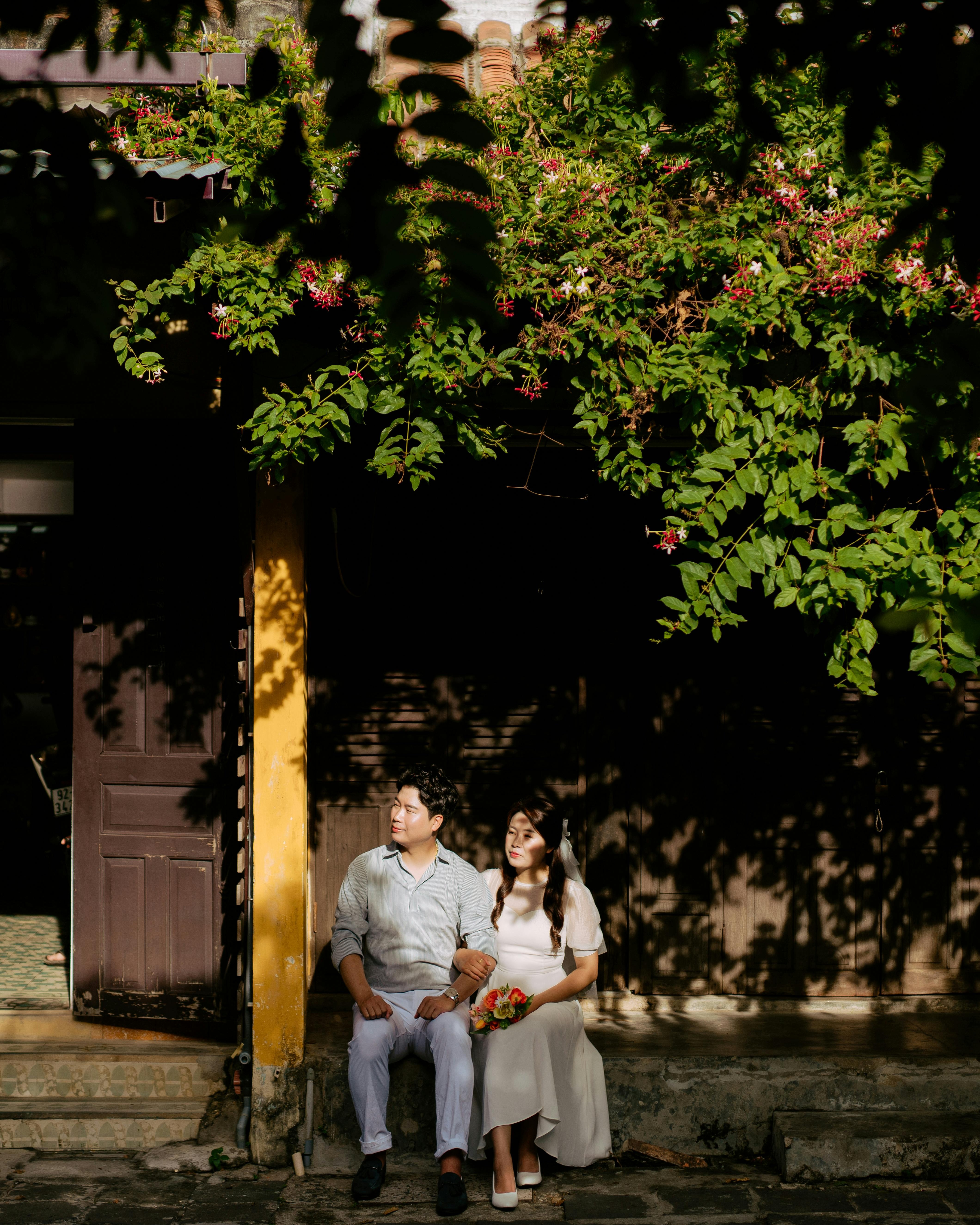 Bride and Groom Under Flowering Vines