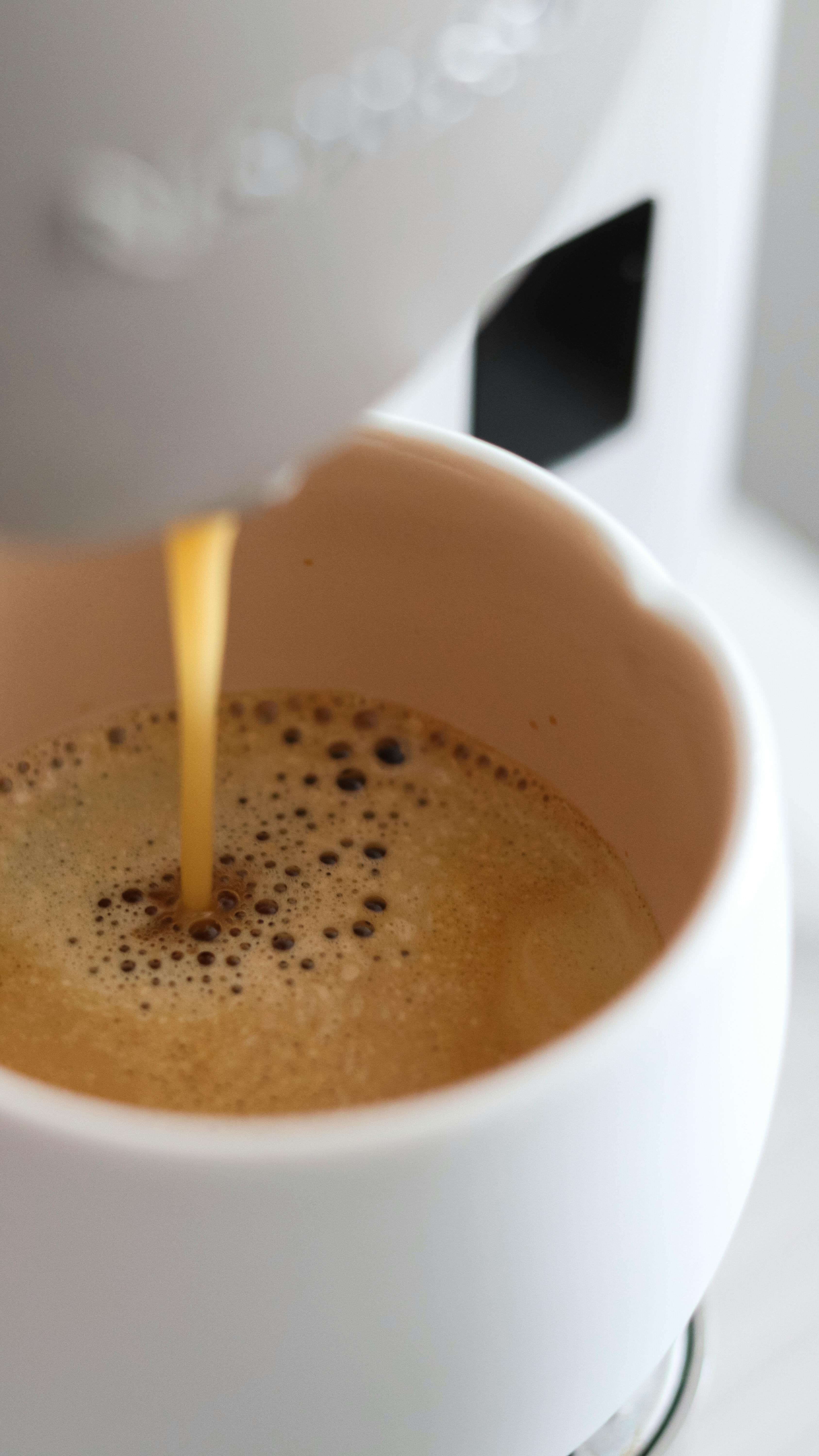 Pouring Coffee Into White Cup