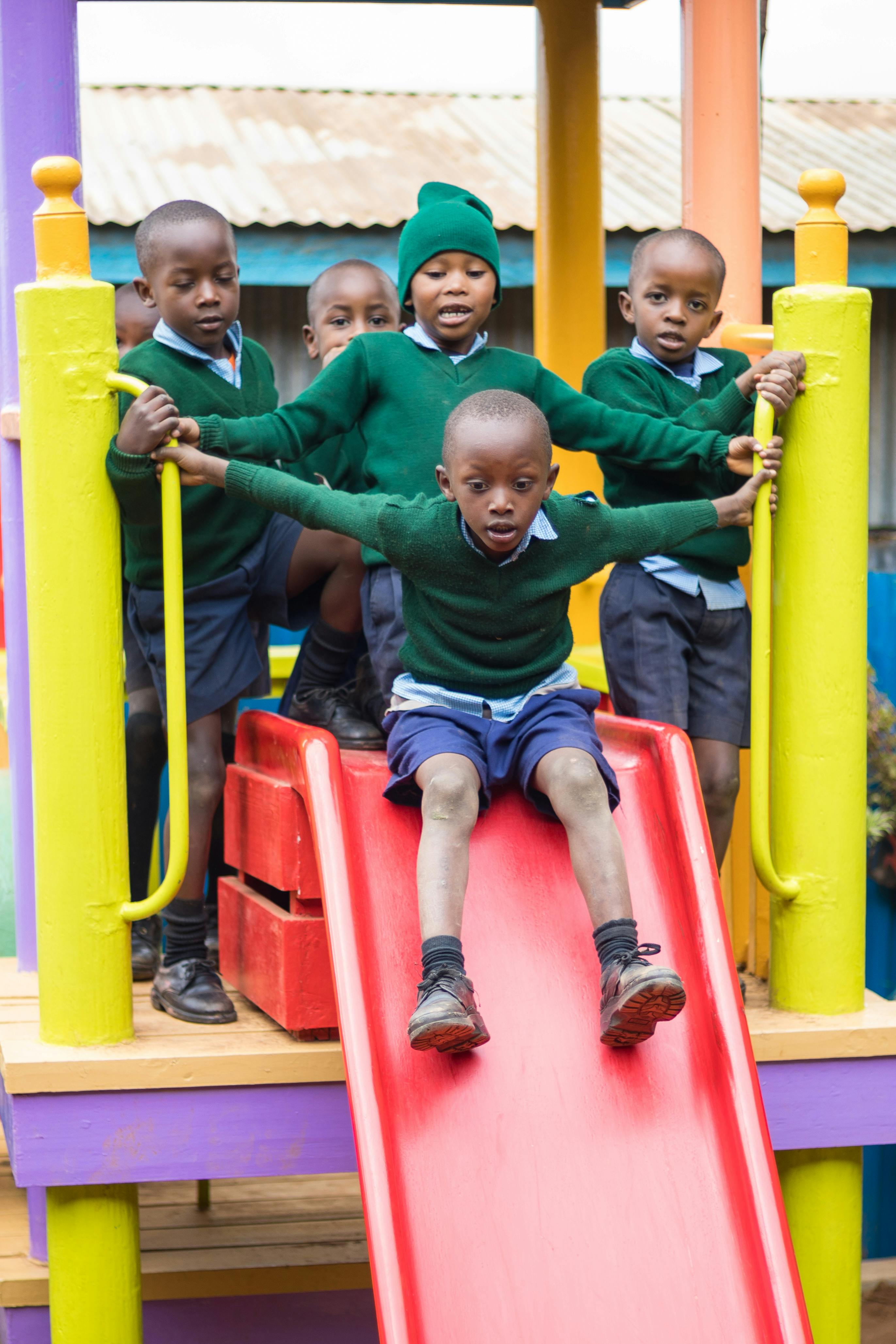 African Schoolchildren on Playground Slide