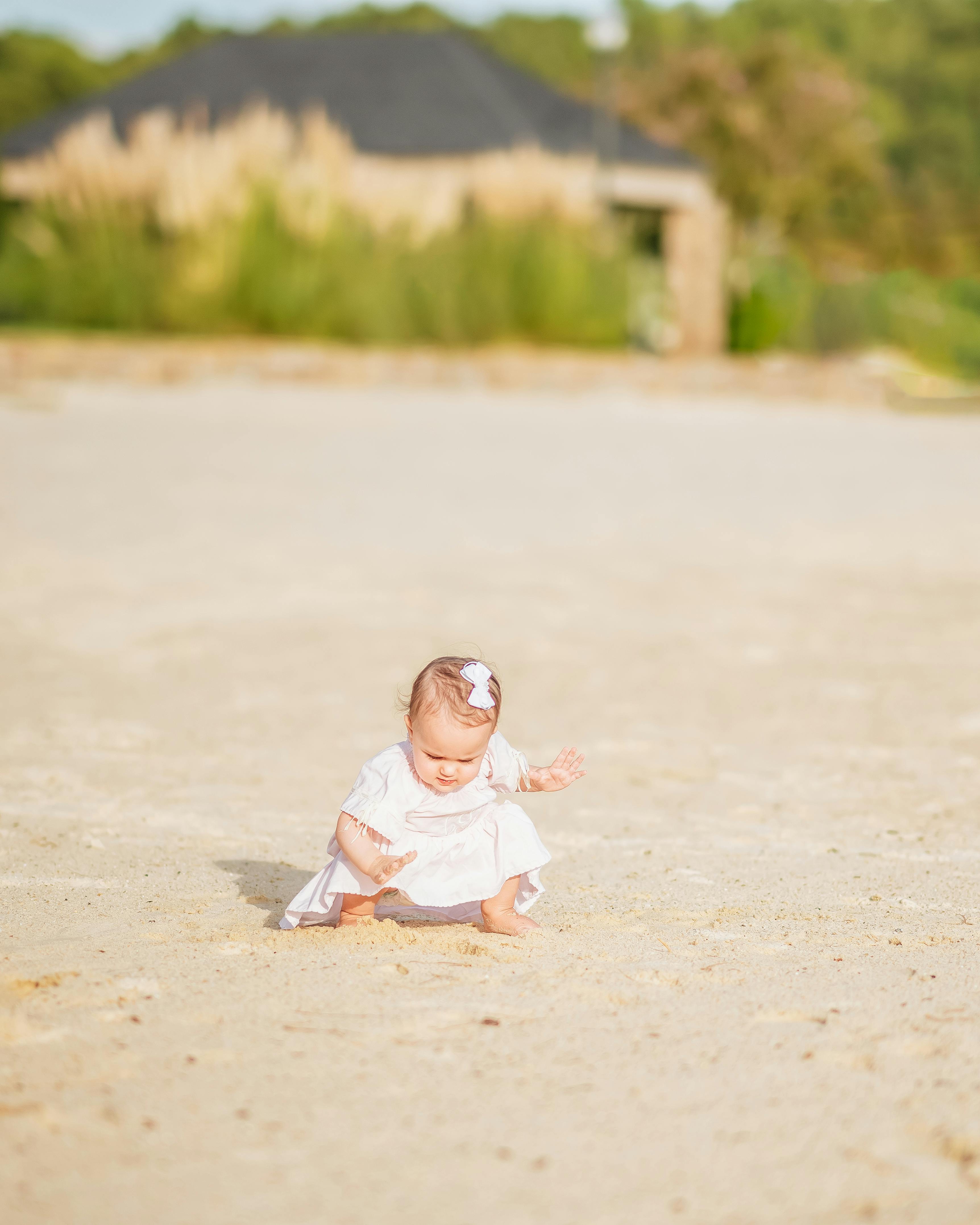Baby Girl Playing on Sandy Beach