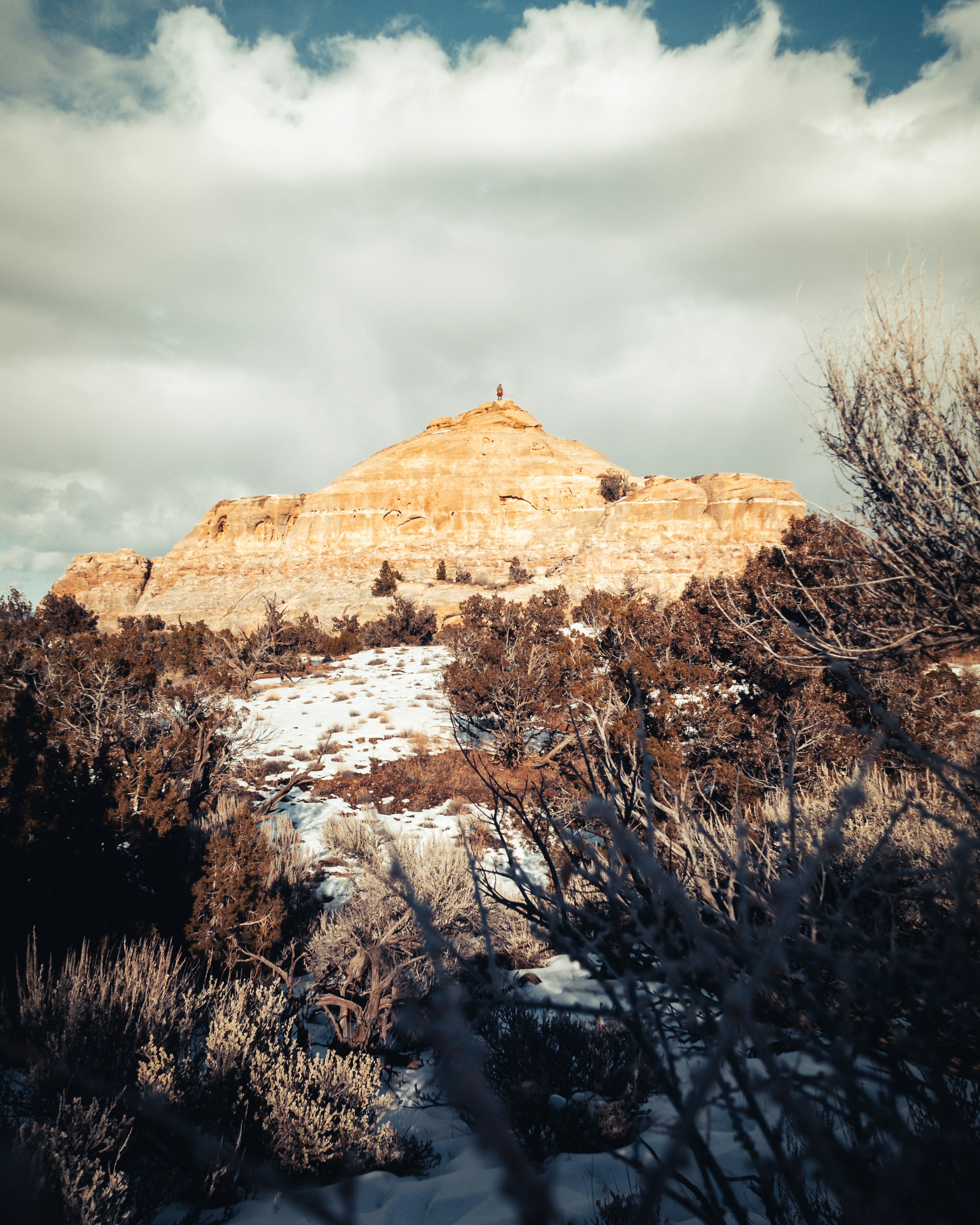 Hiker on Snowy Desert Mesa Peak