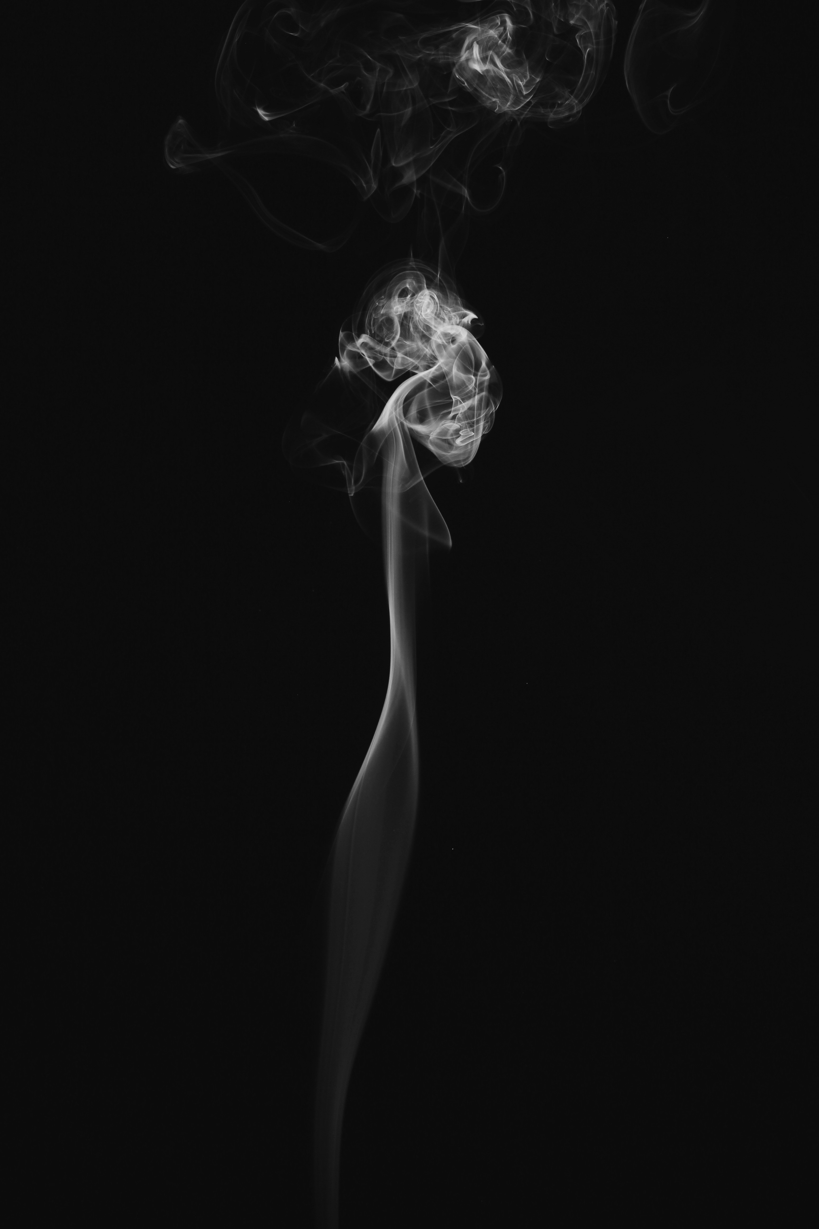 Rising White Smoke on Black Background