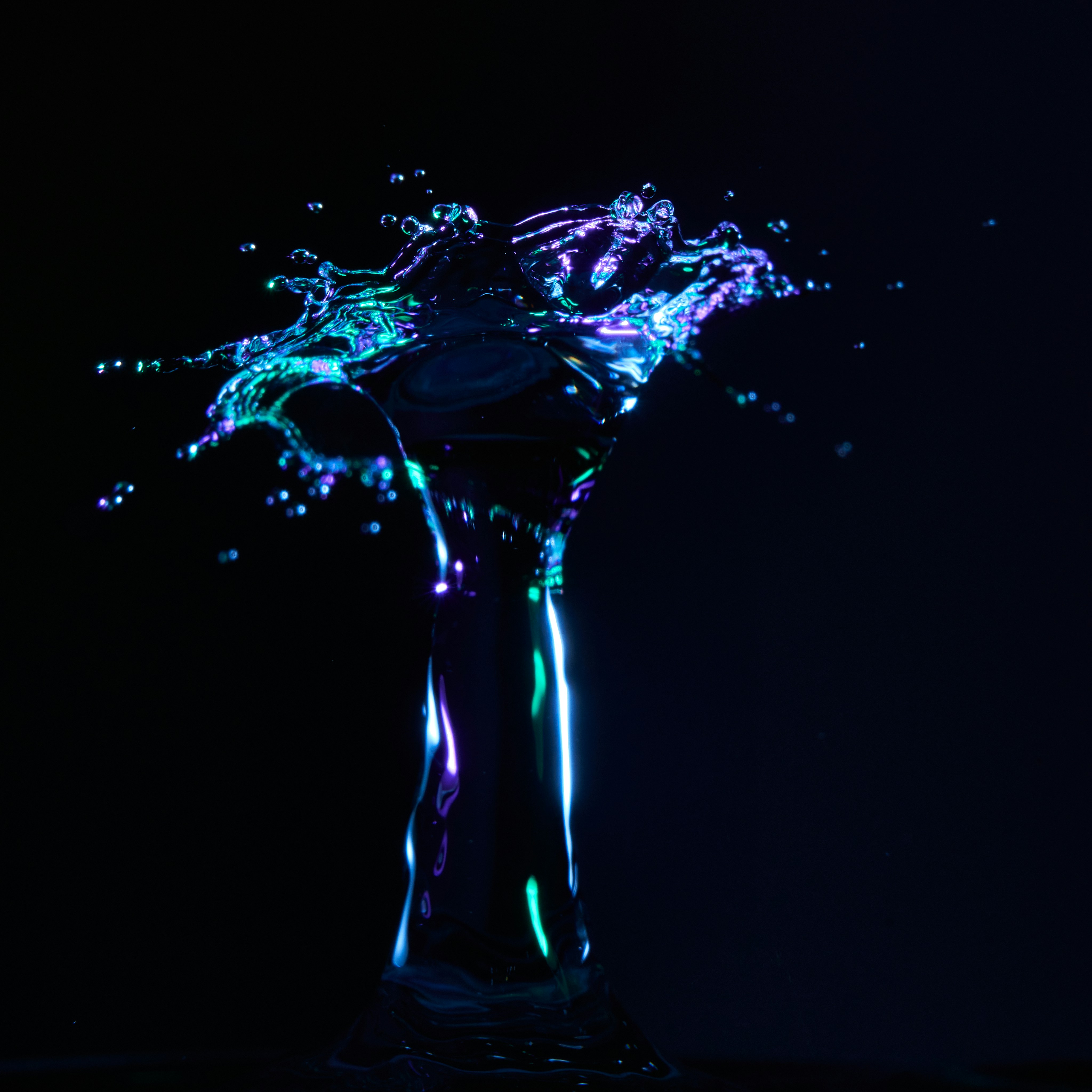 Glowing Water Splash on Black Background