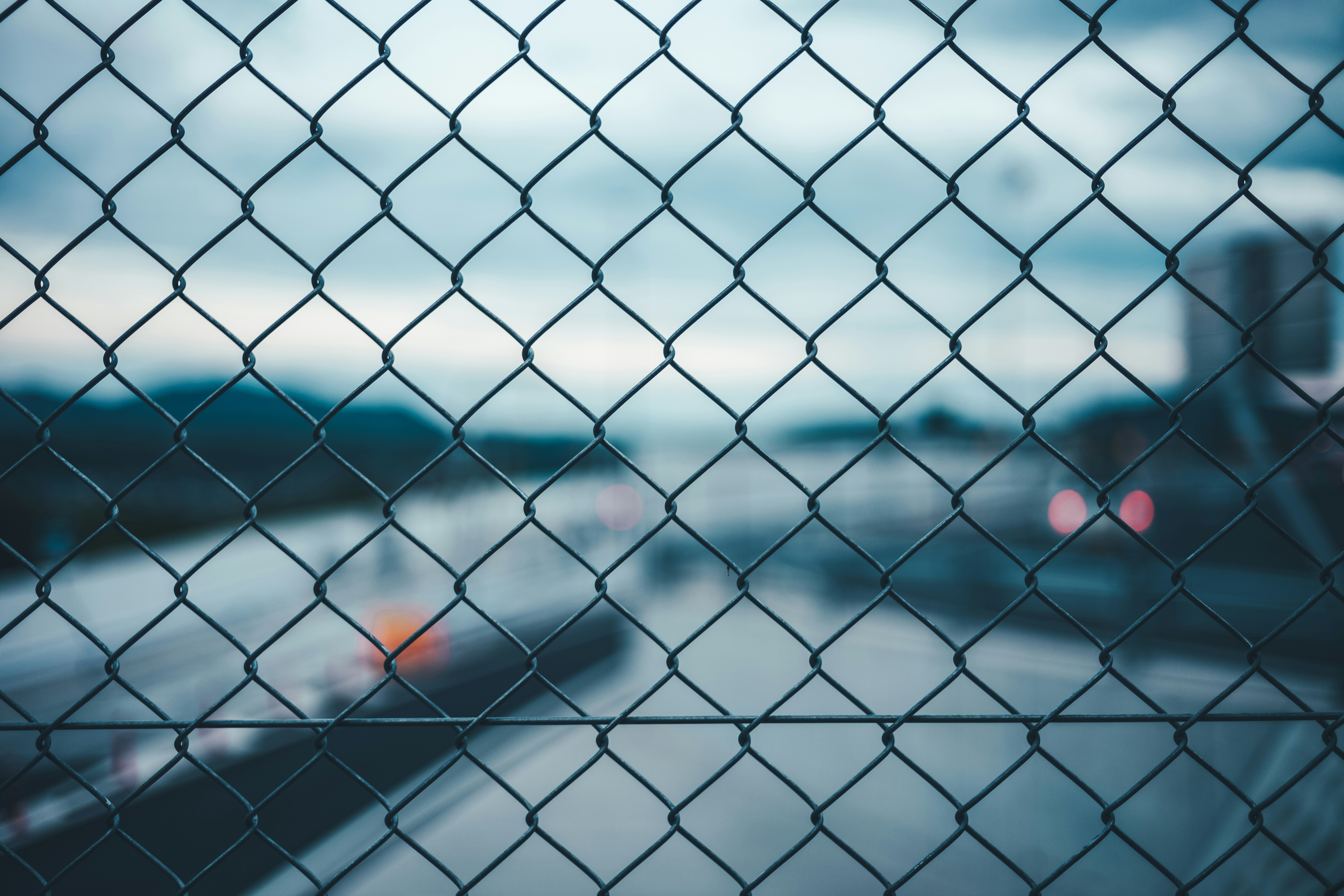 Chain Link Fence Against Blurred Road