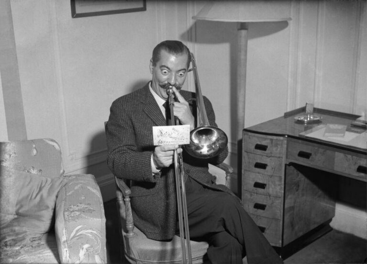 Man With Exaggerated Expression Holds Trombone