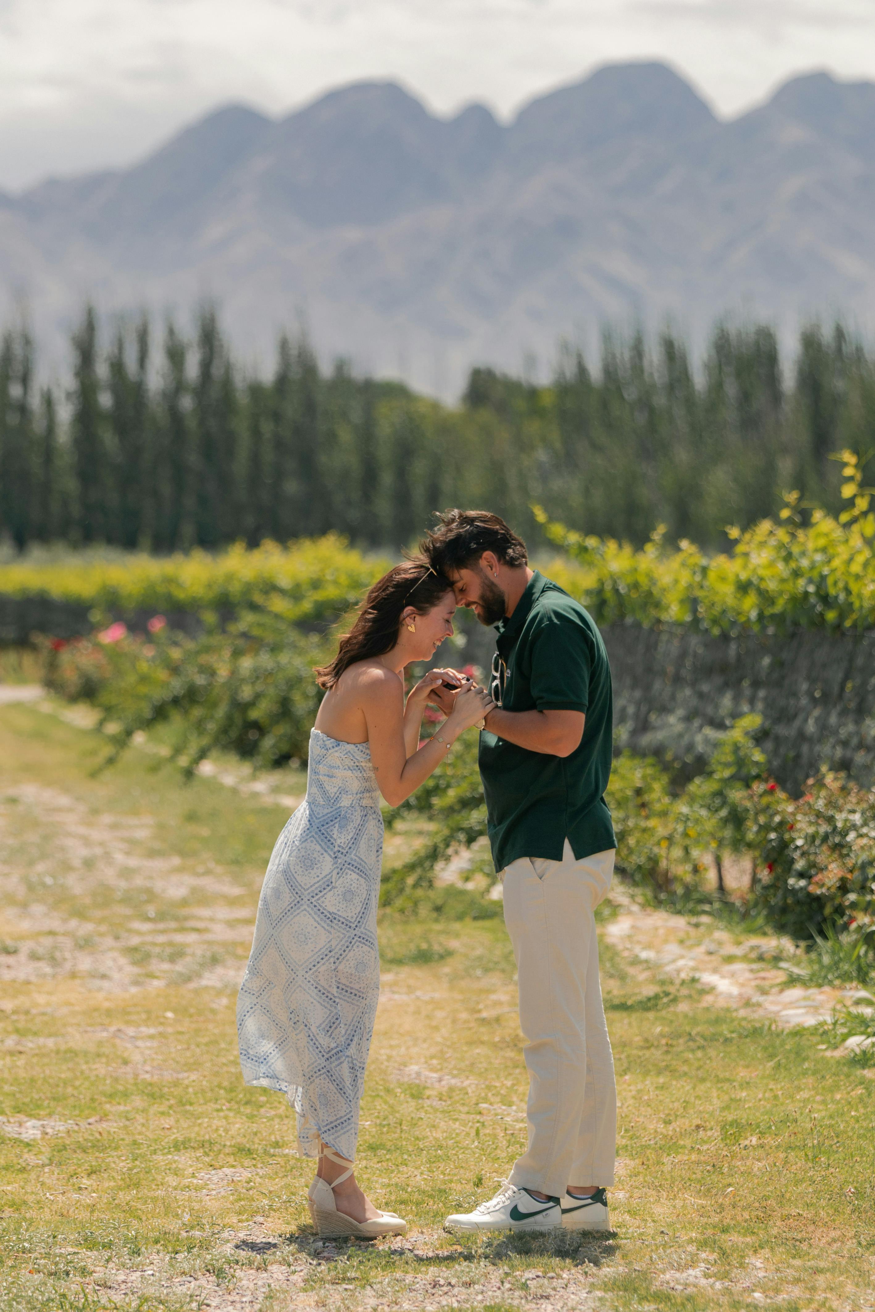 Engaged Couple in Vineyard with Mountains