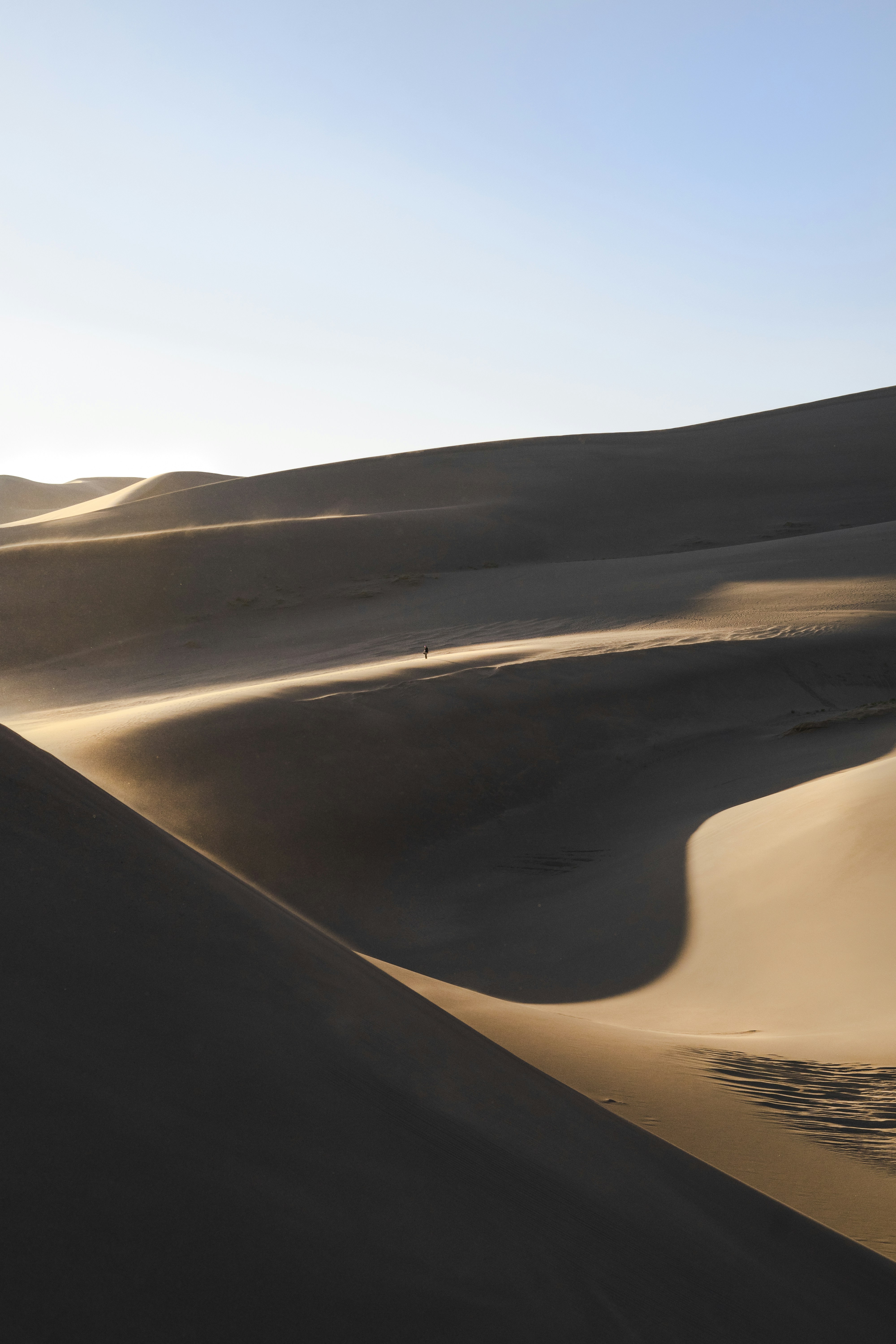 Lone Walker on Desert Sand Dunes