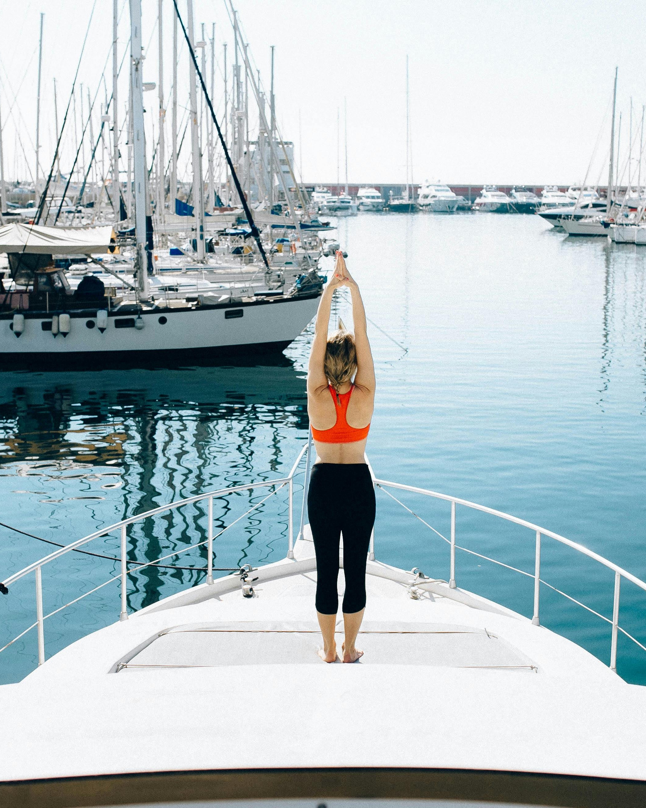 Woman Doing Yoga on Yacht at Marina
