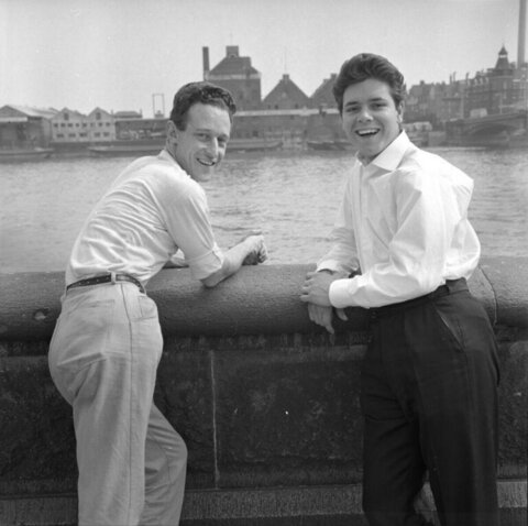 Two Men By River Embankment