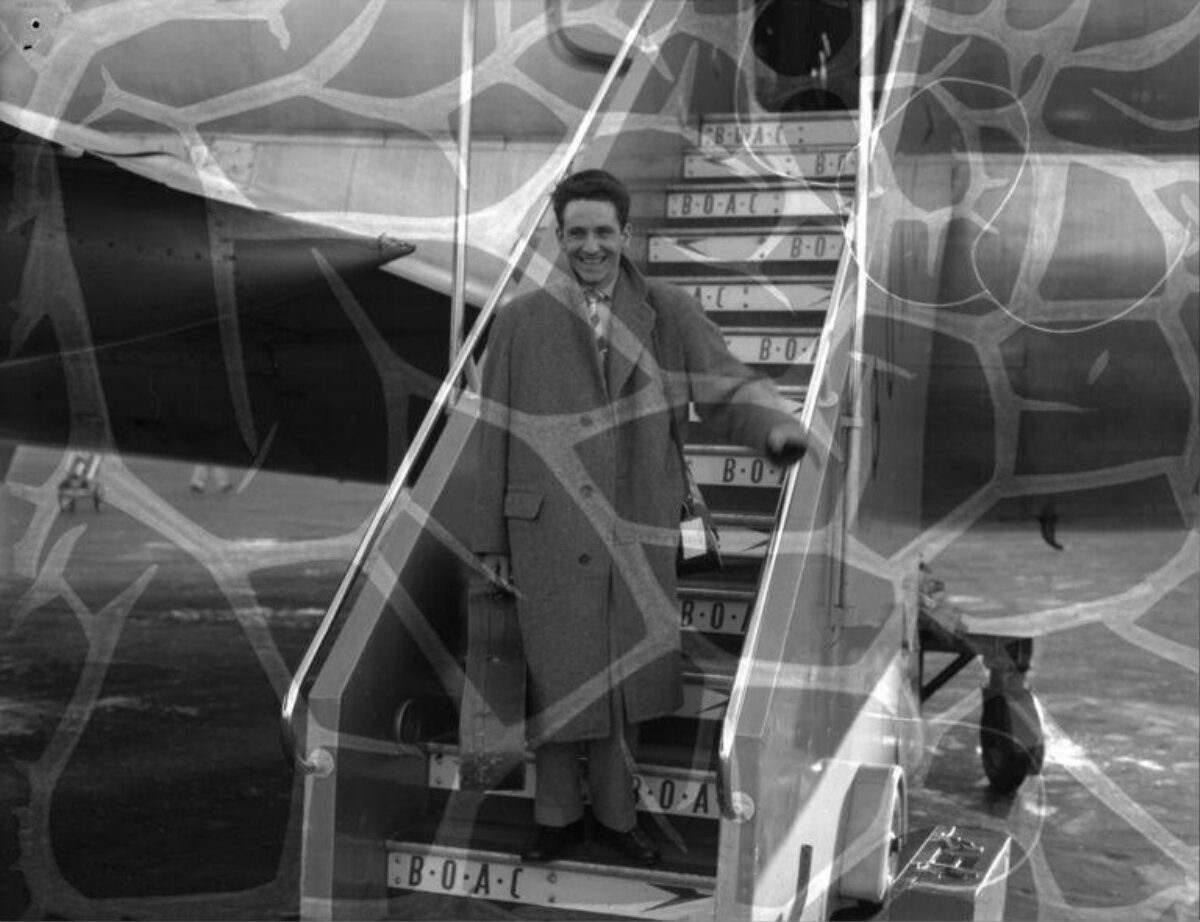 Smiling Man on Airplane Boarding Stairs