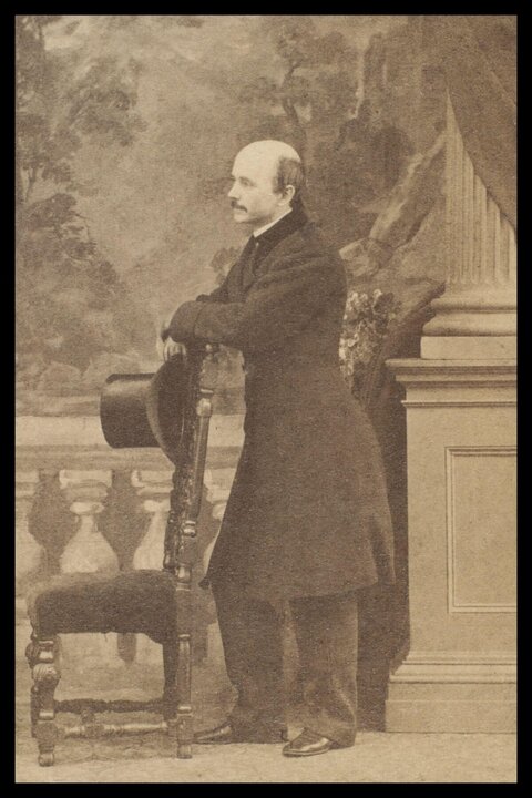 Victorian Bald Man Leaning on Chair