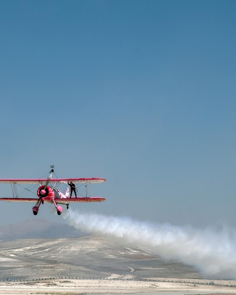 Wing Walking Stunt on Pink Biplane