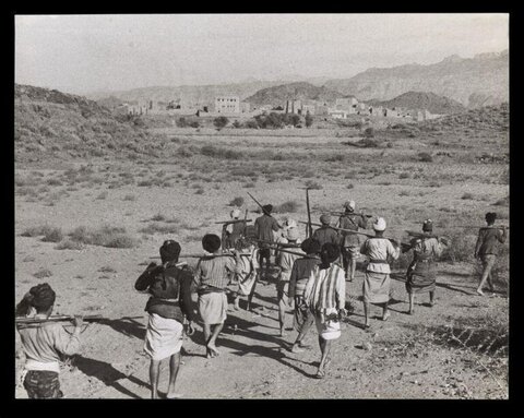 Armed Men Marching Toward Village