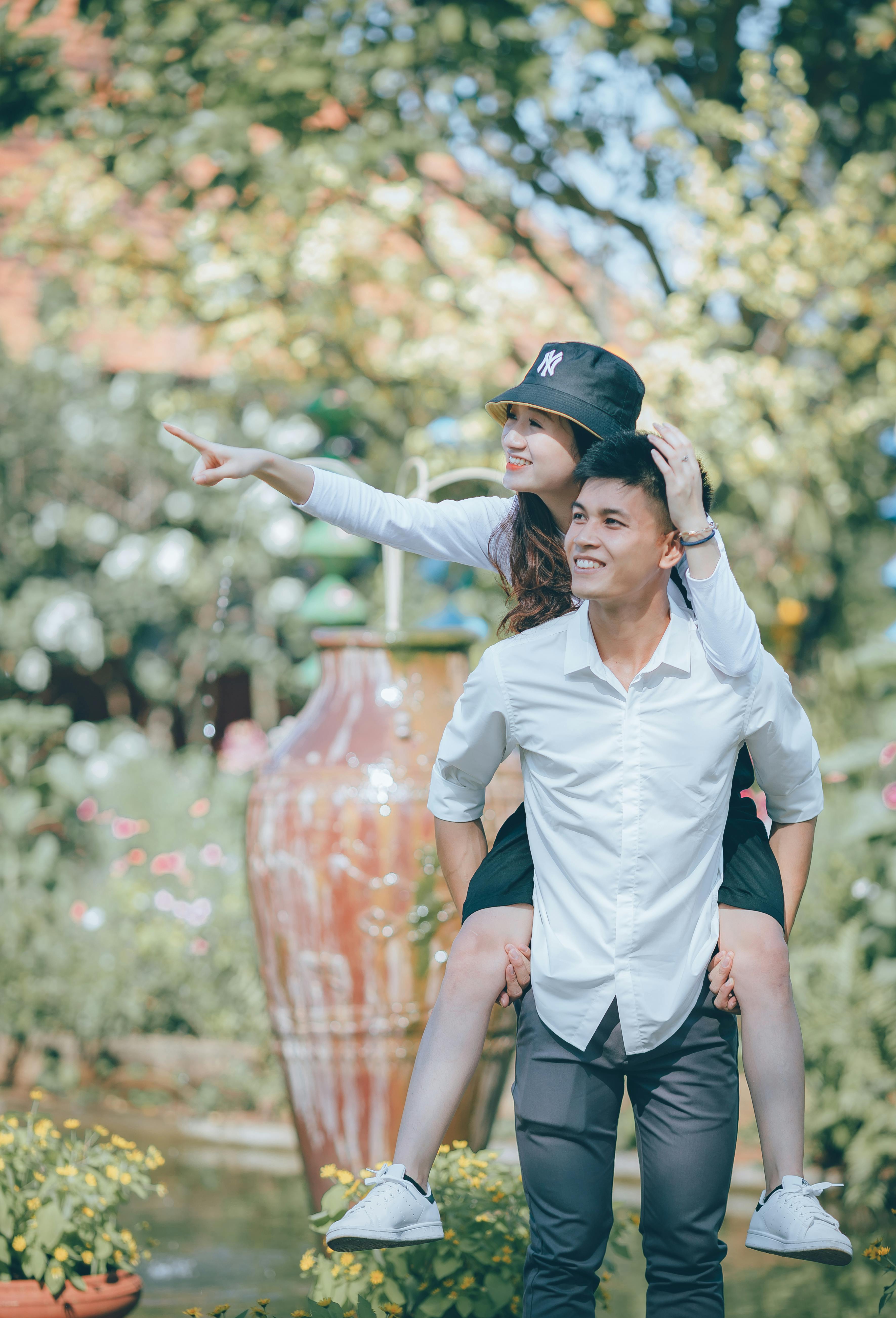 Young Couple Piggyback in Garden