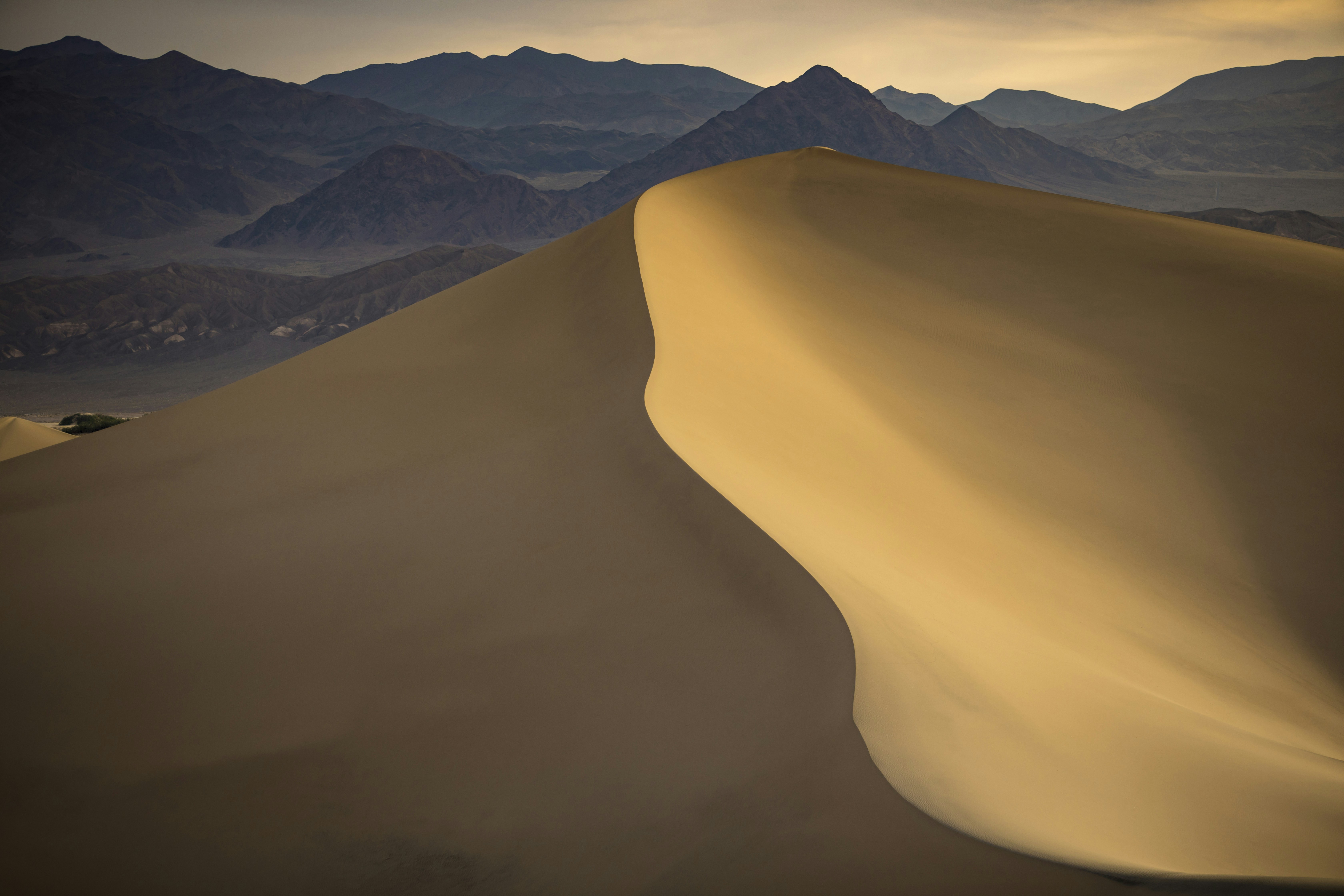 Desert Sand Dune with Distant Mountains