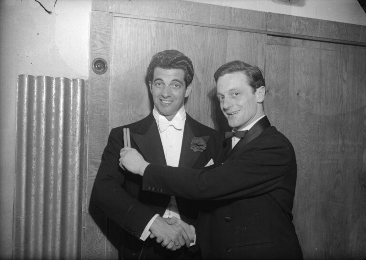 Two Men in Tuxedos Posing Together