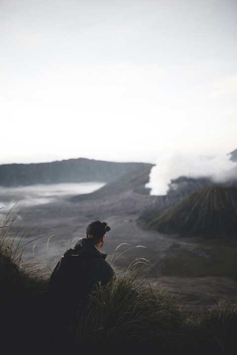 Hiker Overlooking Active Volcano