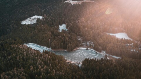 Aerial View of Frozen Lake in Winter Forest