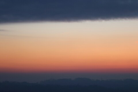 Dusk Sky Over Misty Hills