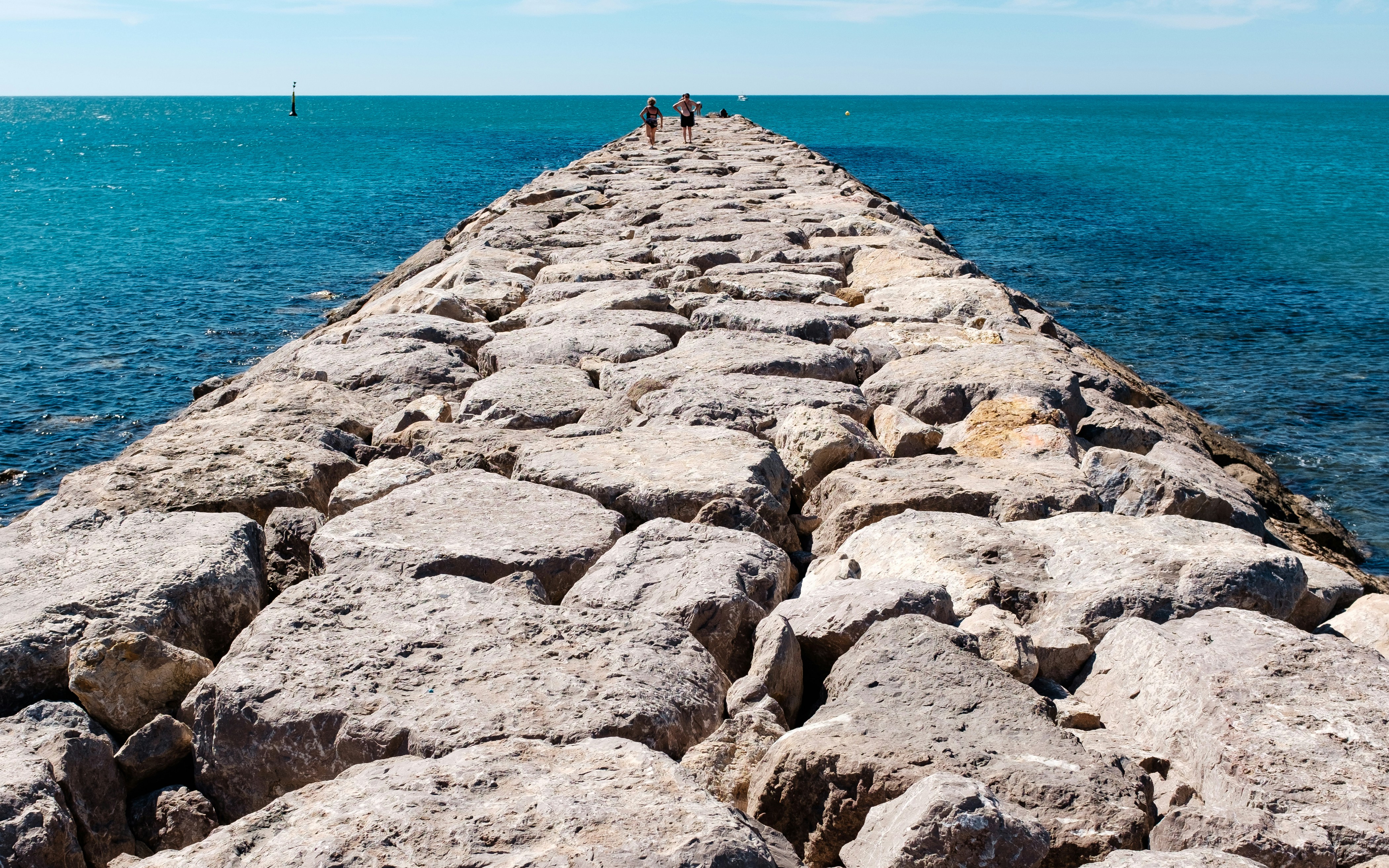 Rocky Breakwater Extending Into Sea