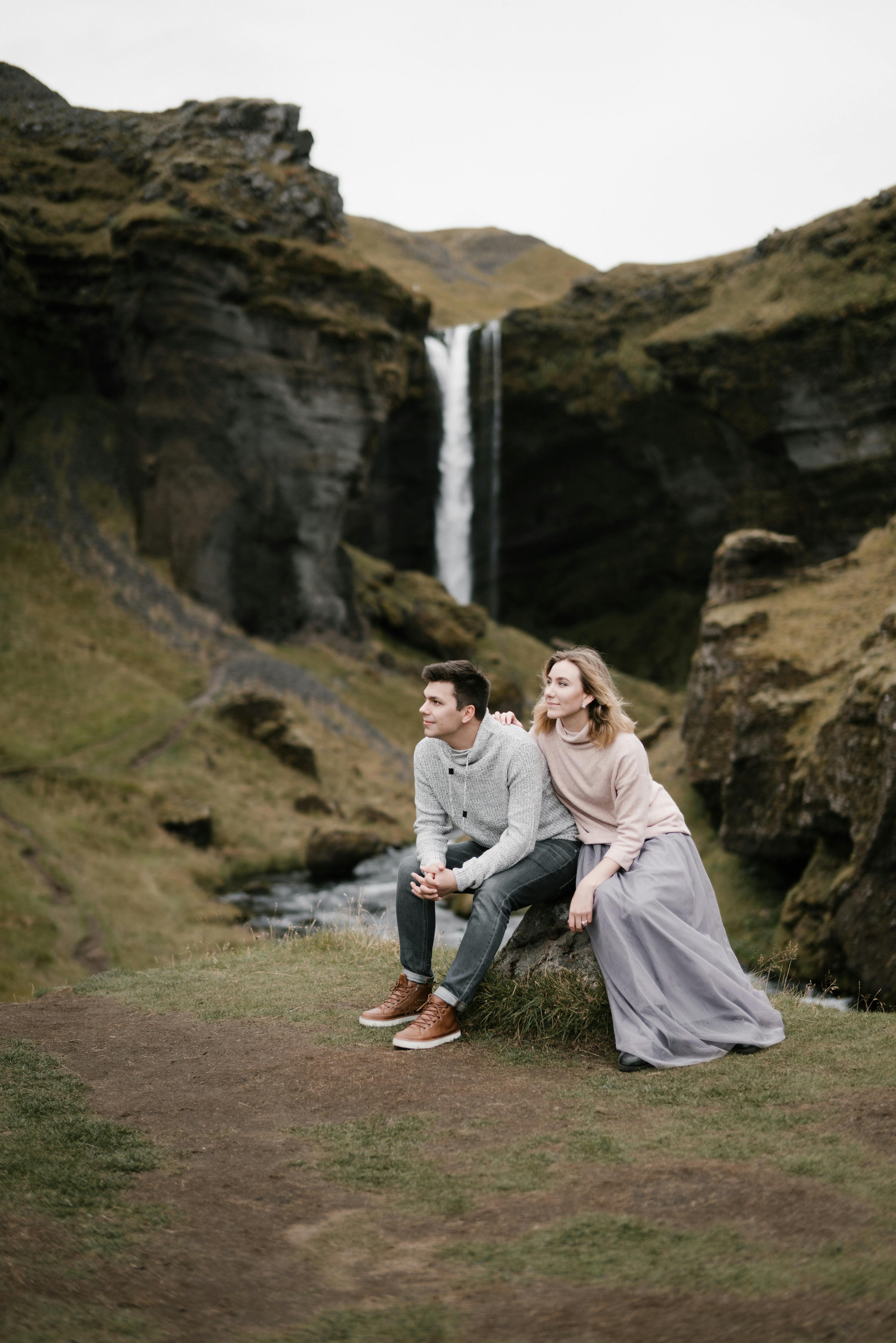 Couple By Mountain Waterfall