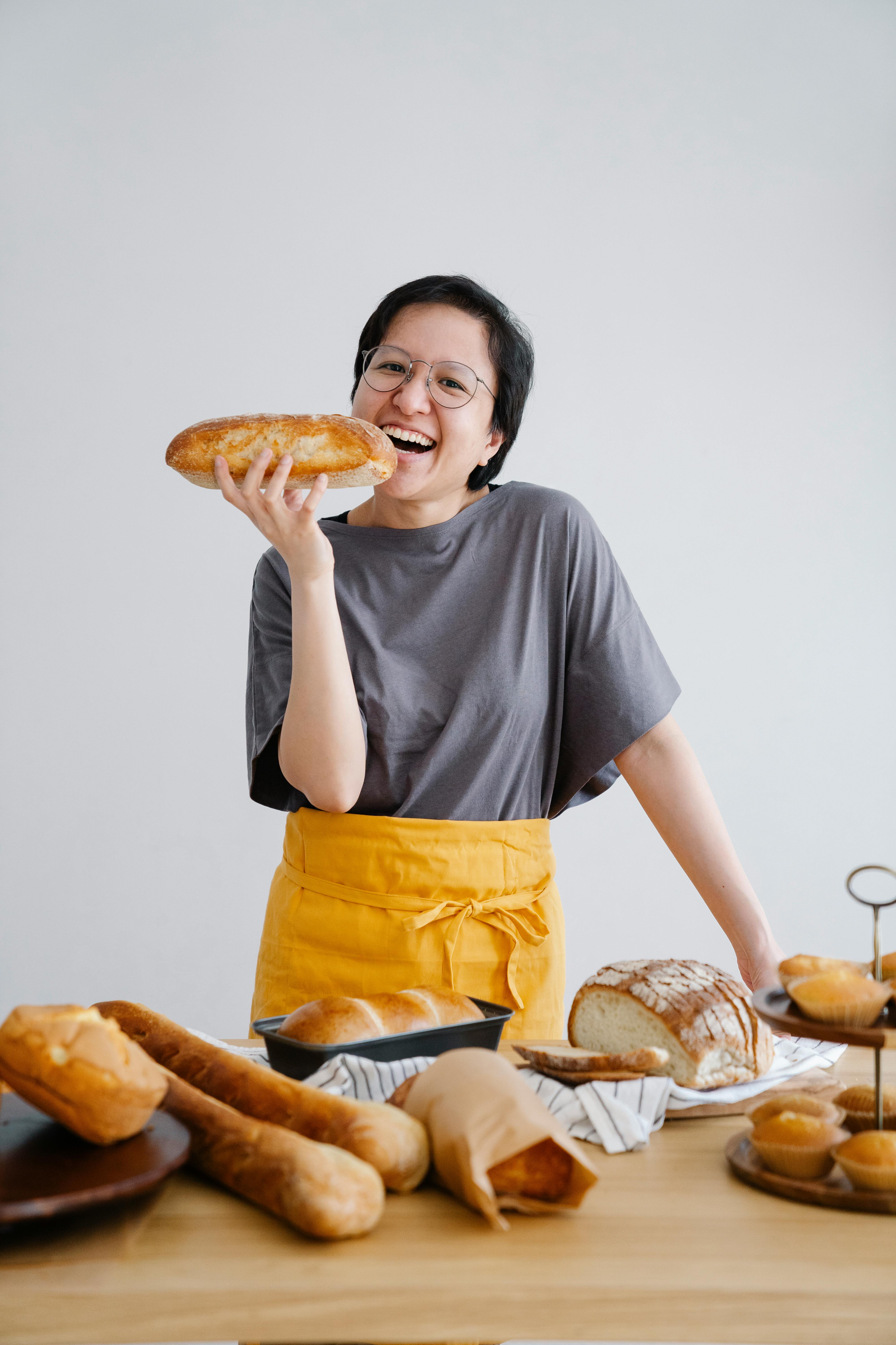 Smiling Baker Holding Fresh Homemade Bread