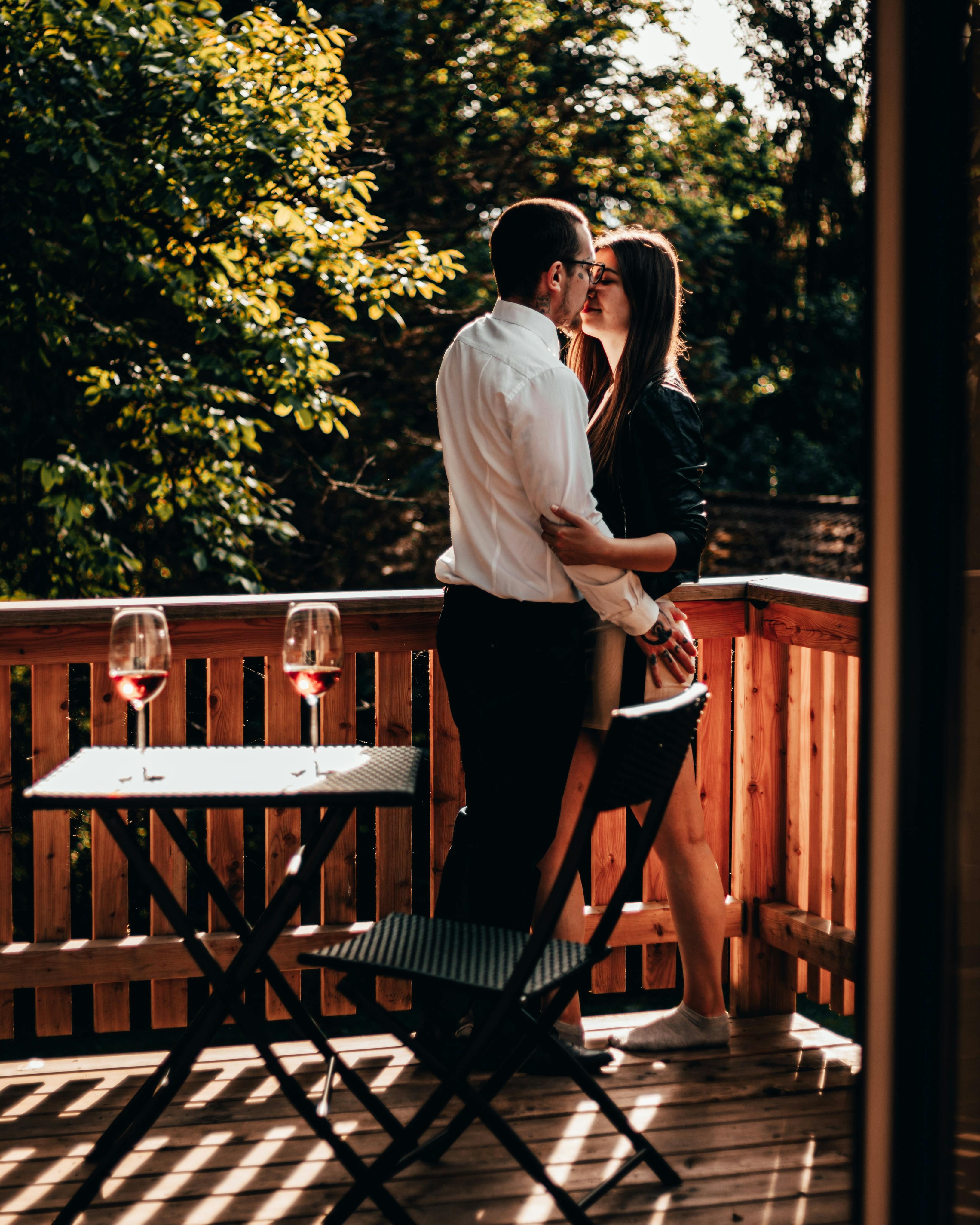 Couple Kissing on Outdoor Balcony