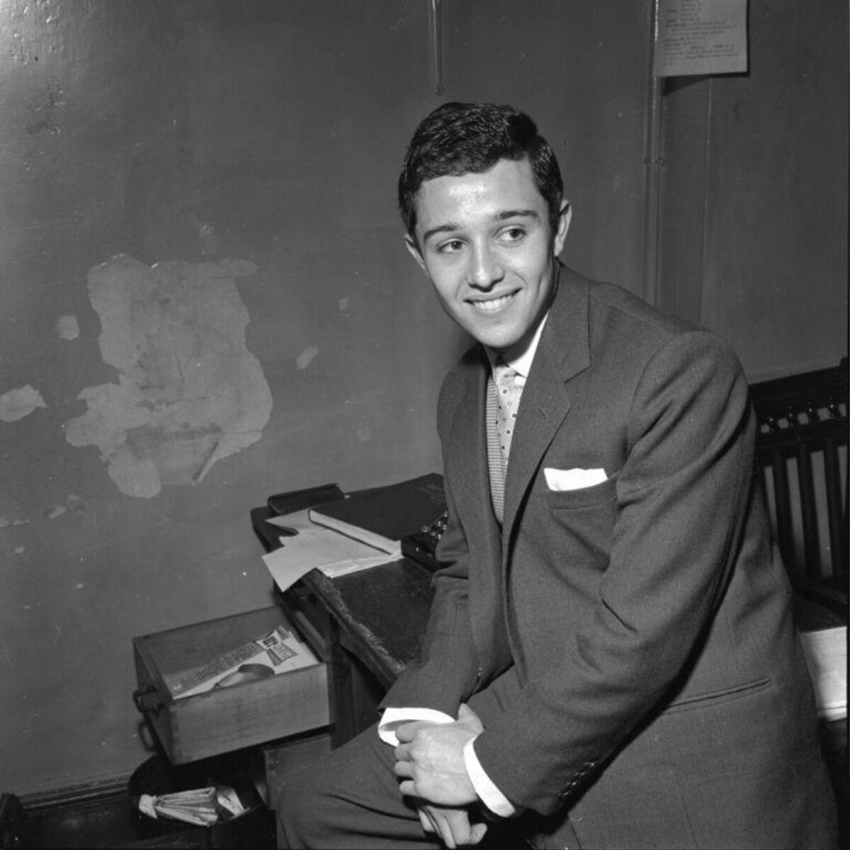 Young Smiling Man In Suit At Desk