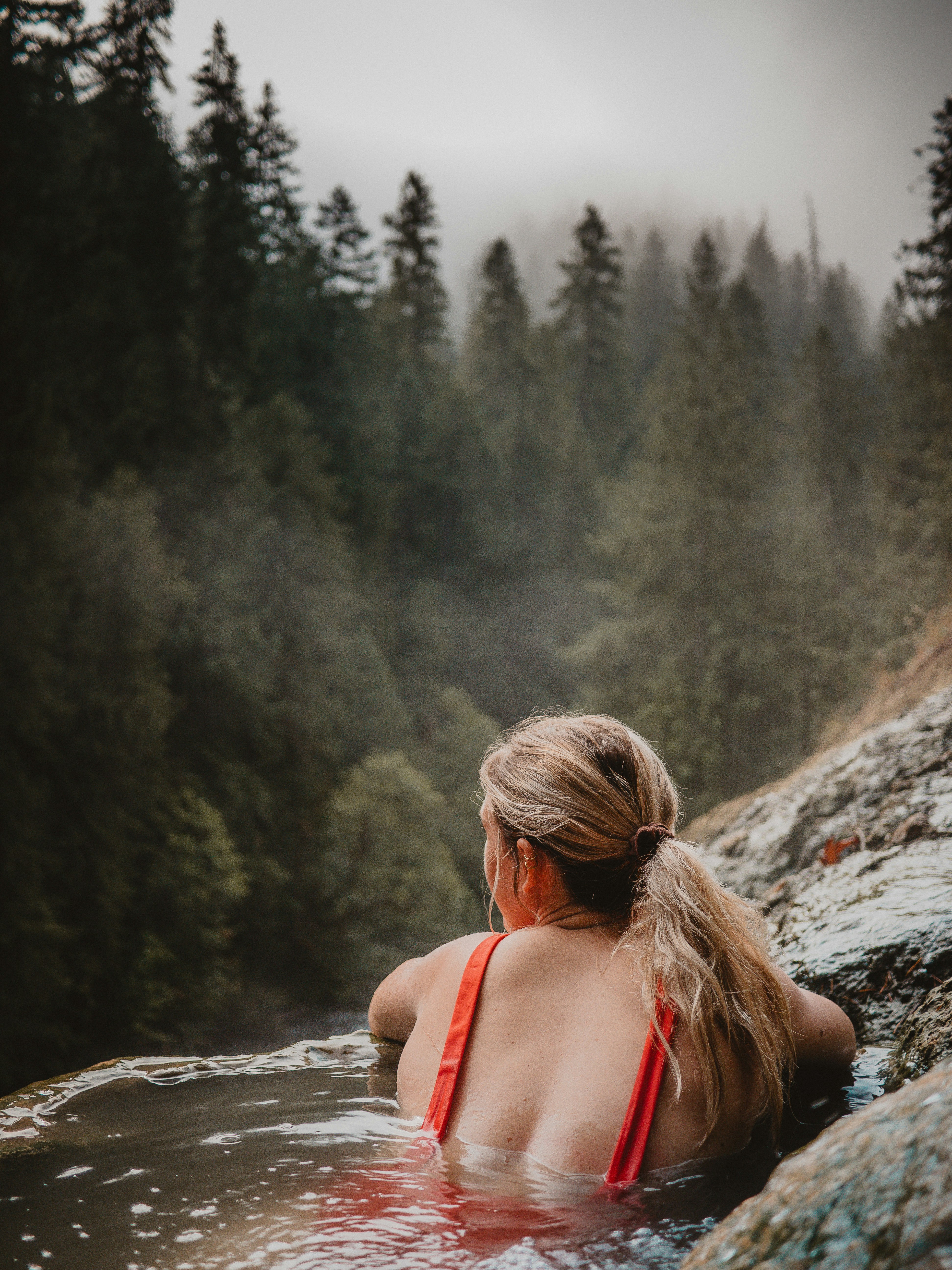 Woman Soaking in Forest Hot Spring
