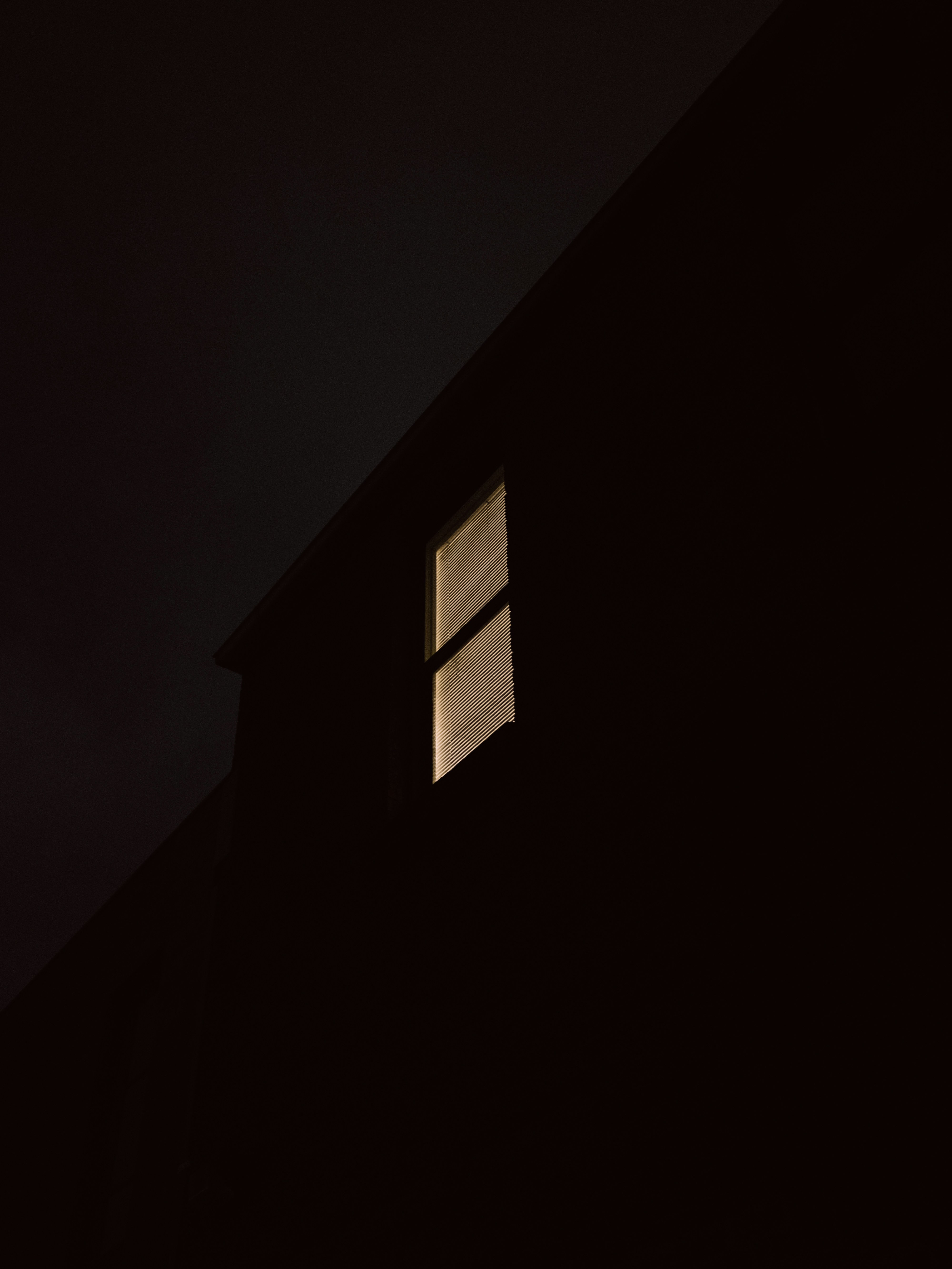 Lit Window of Dark Building at Night