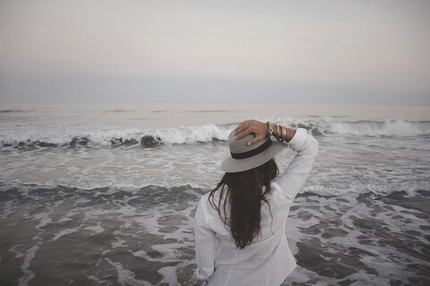 Woman Facing Sea On Beach